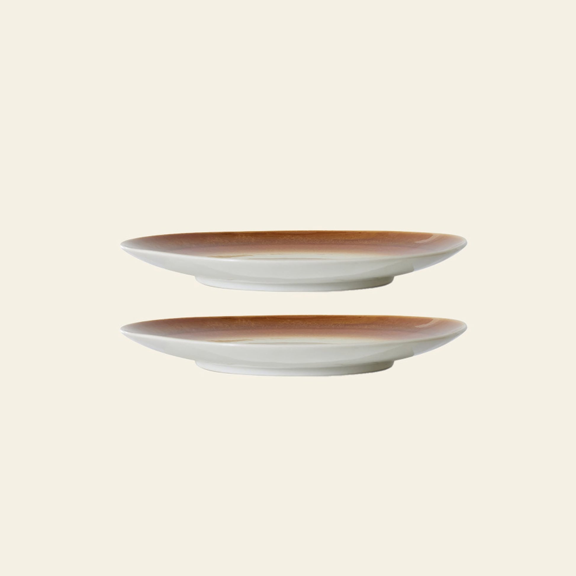The HKLIVING 70s Ceramics: Dinner Plates, Set of 2 - Supernova are shown stacked apart on a beige background, highlighting their unique hand-glazed brown gradient rims and white bases.