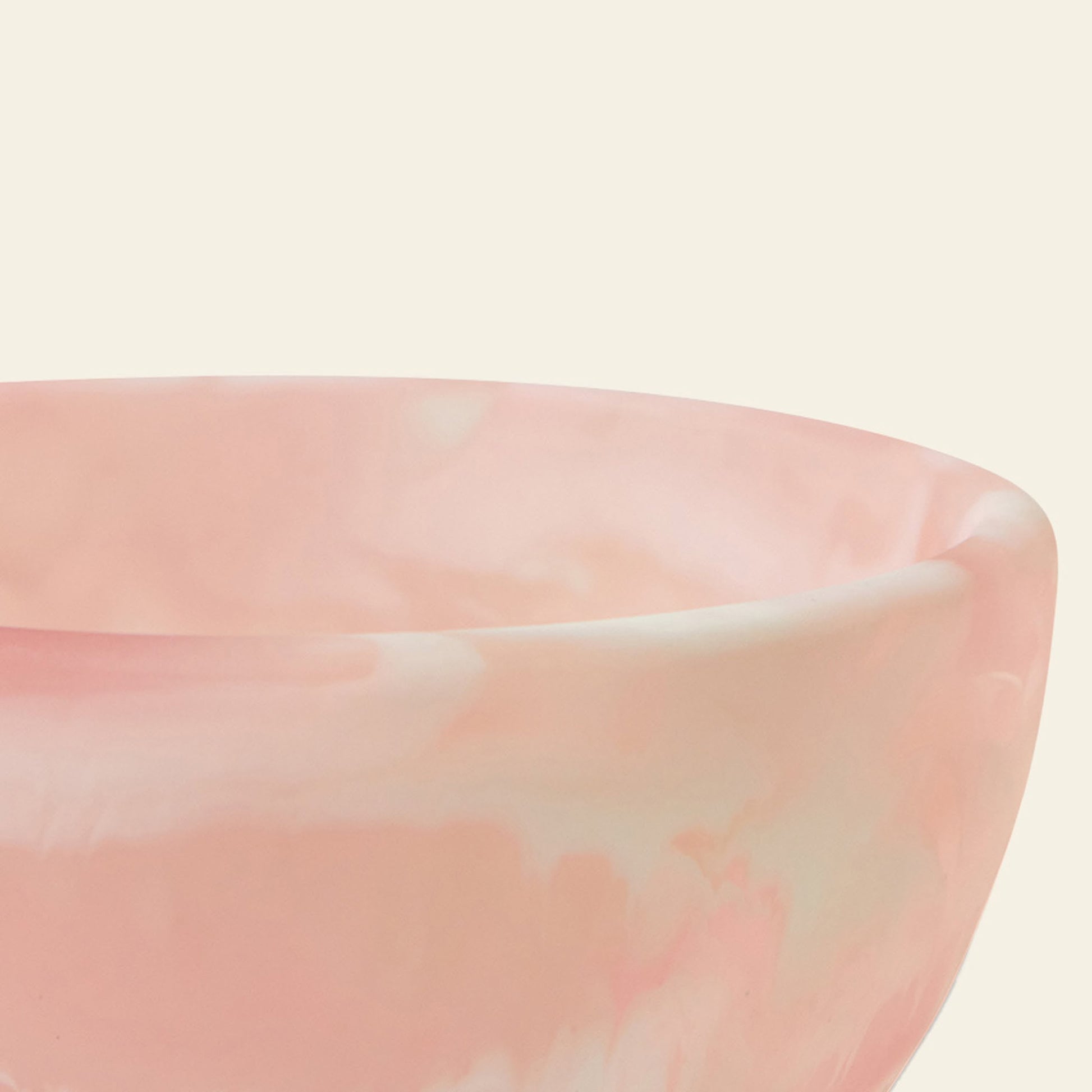 A close-up of the HKLIVING Patio Bowl by HKLIVING, featuring its smooth, glossy pink marbled resin and rounded edge against a light beige background—perfect for stylish outdoor entertaining.