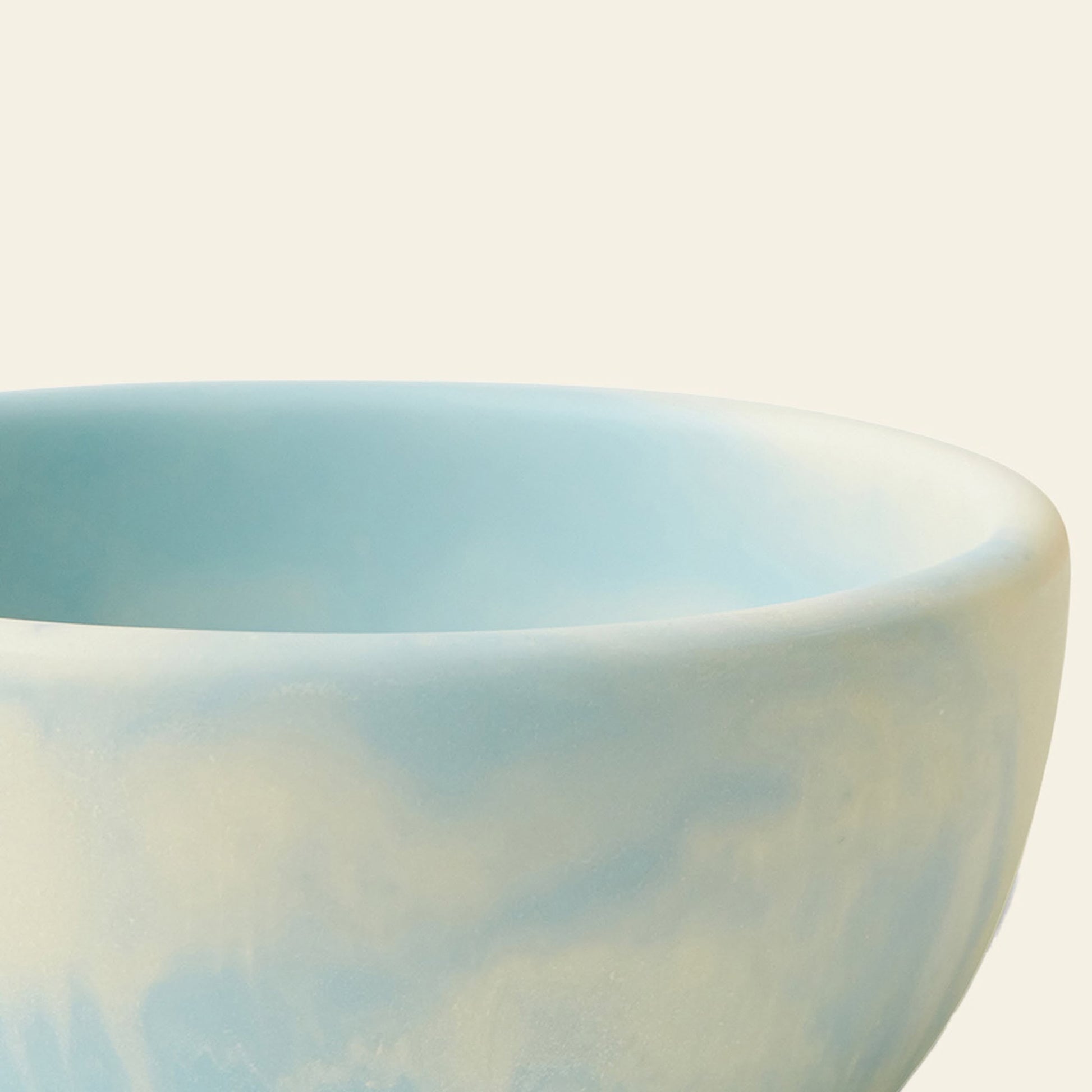 A close-up of the HKLIVING Patio Bowl by HKLIVING, featuring a smooth, matte light blue ceramic finish with part of the rim and side visible against an off-white background—ideal for outdoor entertaining.