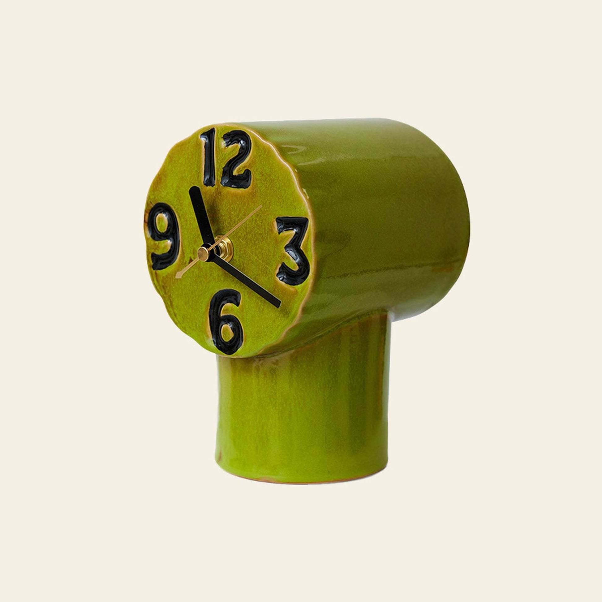 The HKLIVING Retro Ceramic Clock - Olive features a quirky uneven cylindrical shape, raised black numbers, and a nostalgic ceramic finish. Its tilted face and playful hands evoke abstract charm—perfect for adding personality to any room.