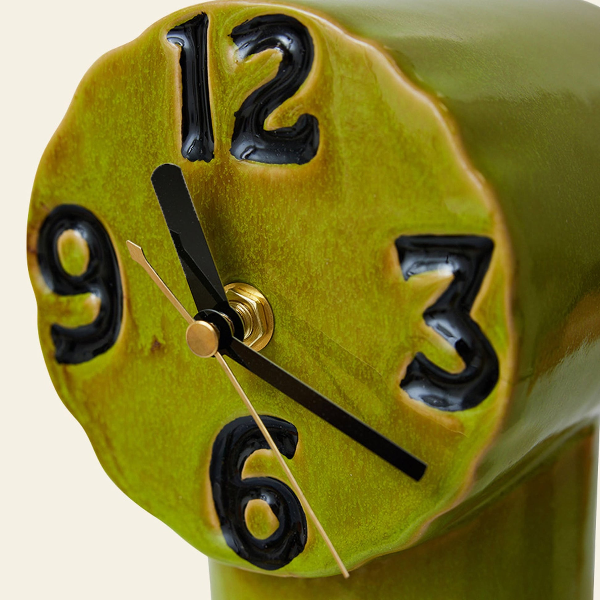 A close-up of the HKLIVING Retro Ceramic Clock - Olive shows its wavy, handmade face with large black uneven numbers and black hands at 10:00, adding nostalgic charm to the vintage-inspired HKLIVING design.