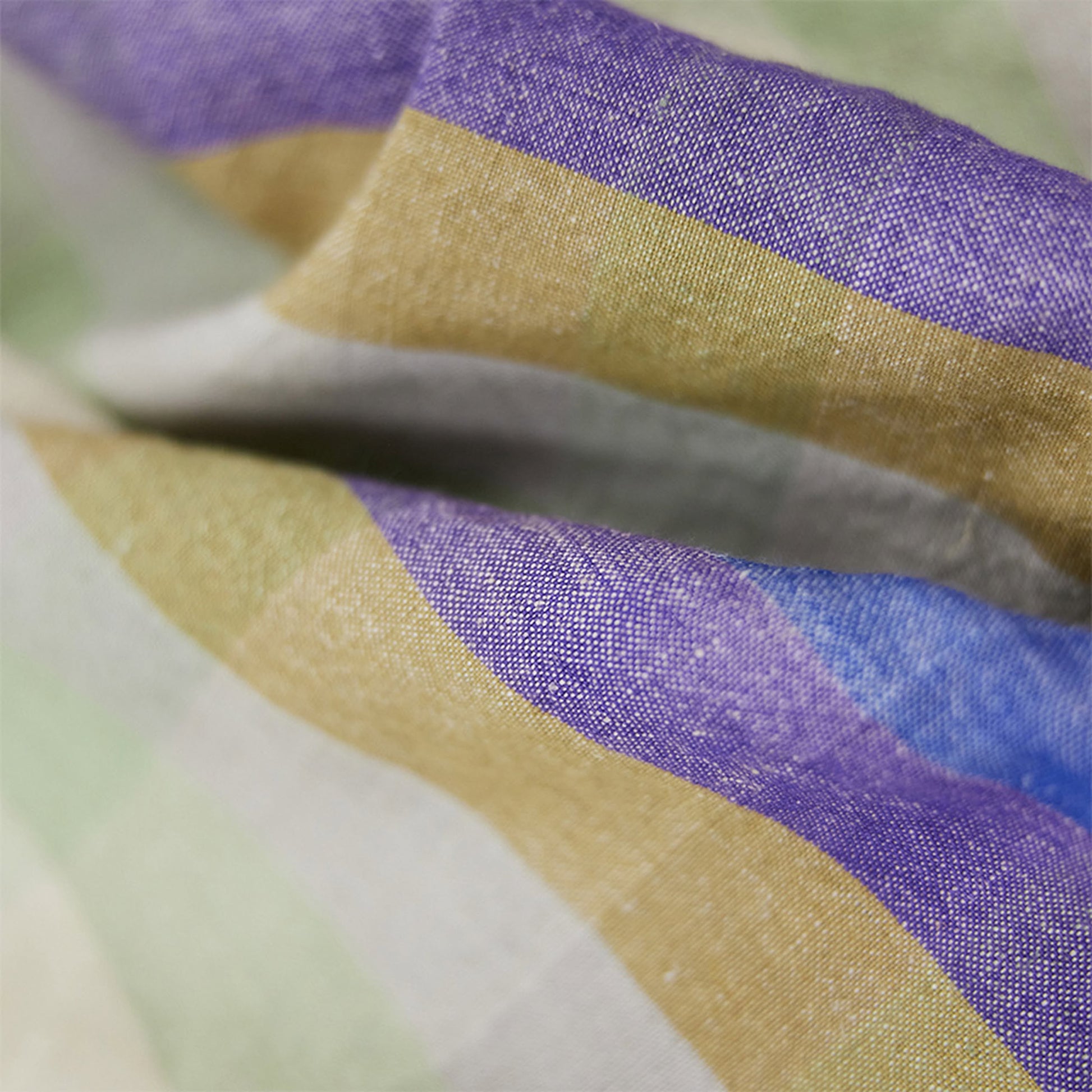 The HKLIVING Vida Check Tea Towel - Multicoloured features wavy folds and horizontal stripes in purple, blue, gold, green, and off-white. Its premium blend fabric is absorbent with a soft woven appearance.