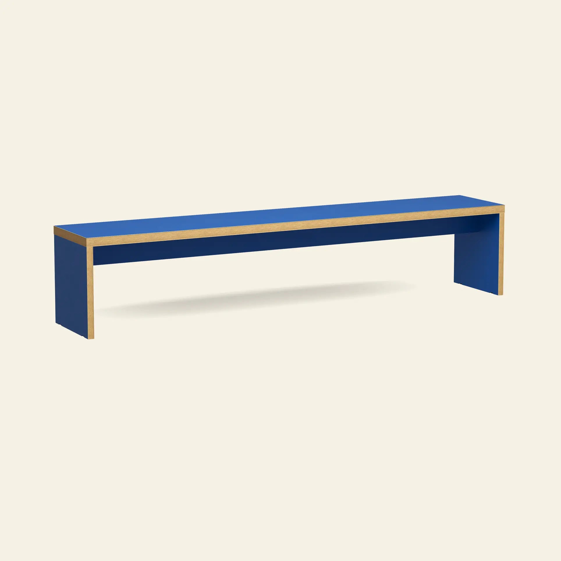 The HKliving Bench, 220cm by HKliving, features a minimalist blue rectangular design with simple lines and exposed wooden edges—ideal as space-saving dining table seating—shown against a plain off-white background.
