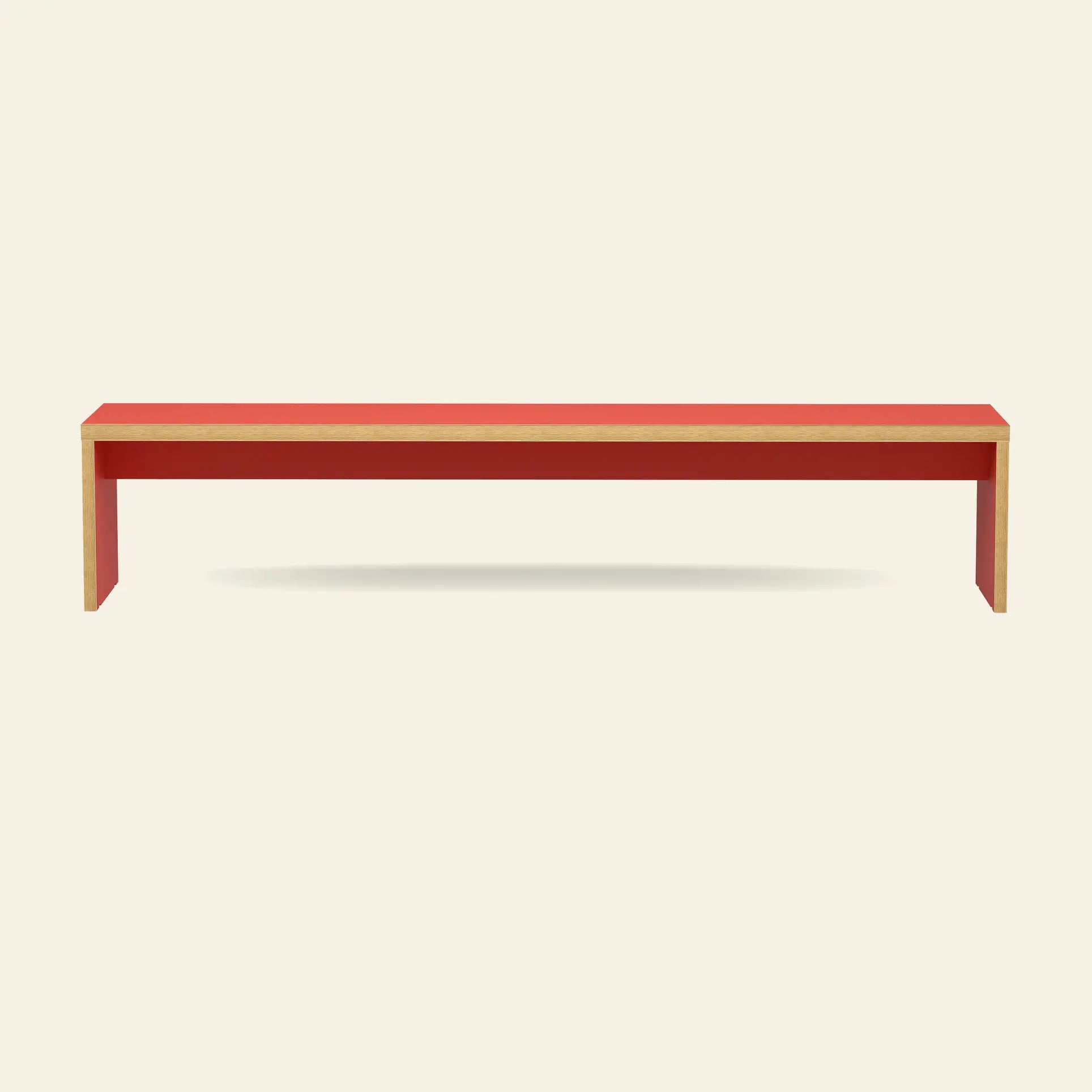 The HKliving Bench, 220cm by HKliving is a modern wooden bench with a red top and sides, viewed front-on against a light background. Its minimalist, space-saving design with clean lines pairs well with dining tables or other benches.