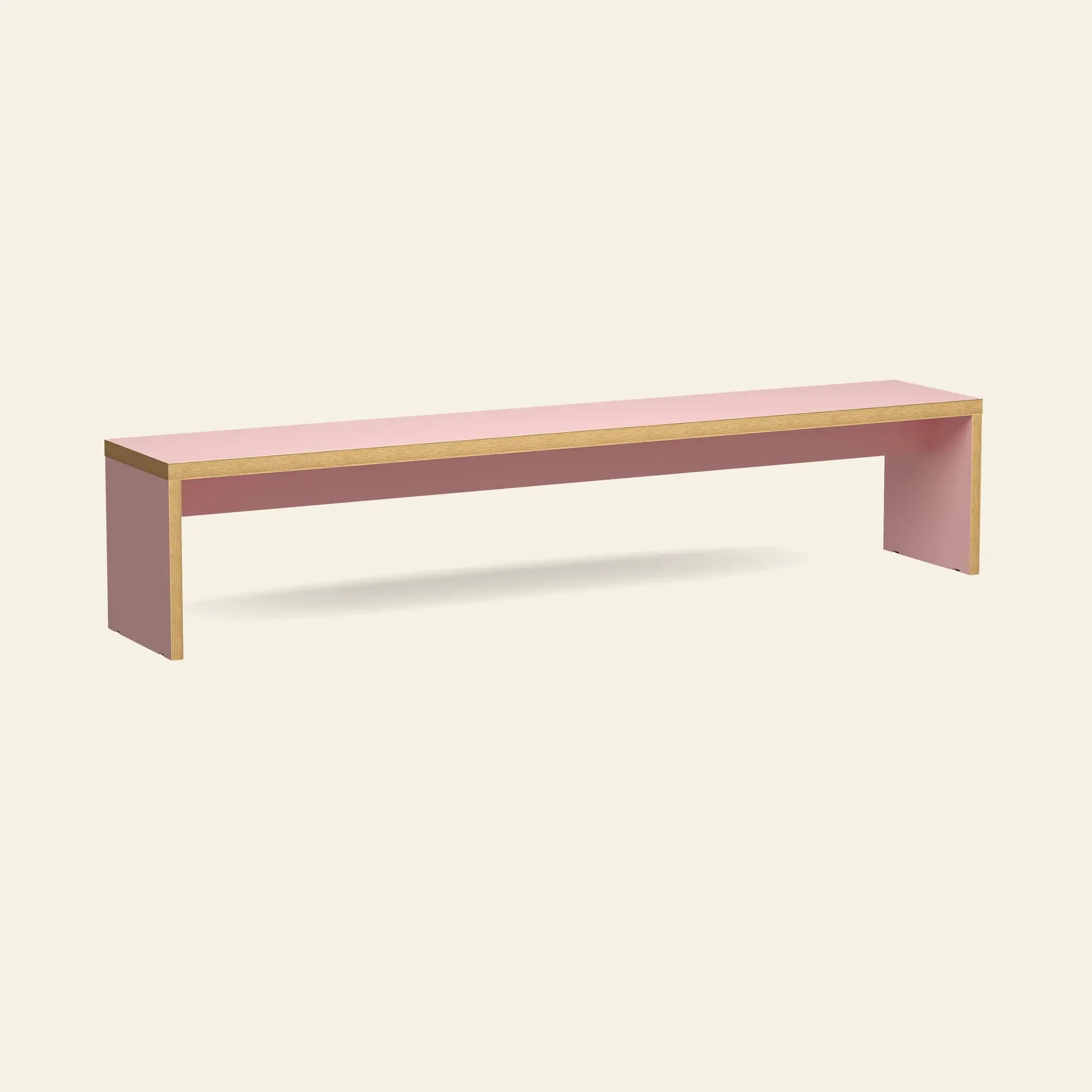 The HKliving Bench, 220cm by HKliving, is a minimalist rectangular pink bench with wooden edges, crafted as a space-saving accent and shown against a plain beige background.