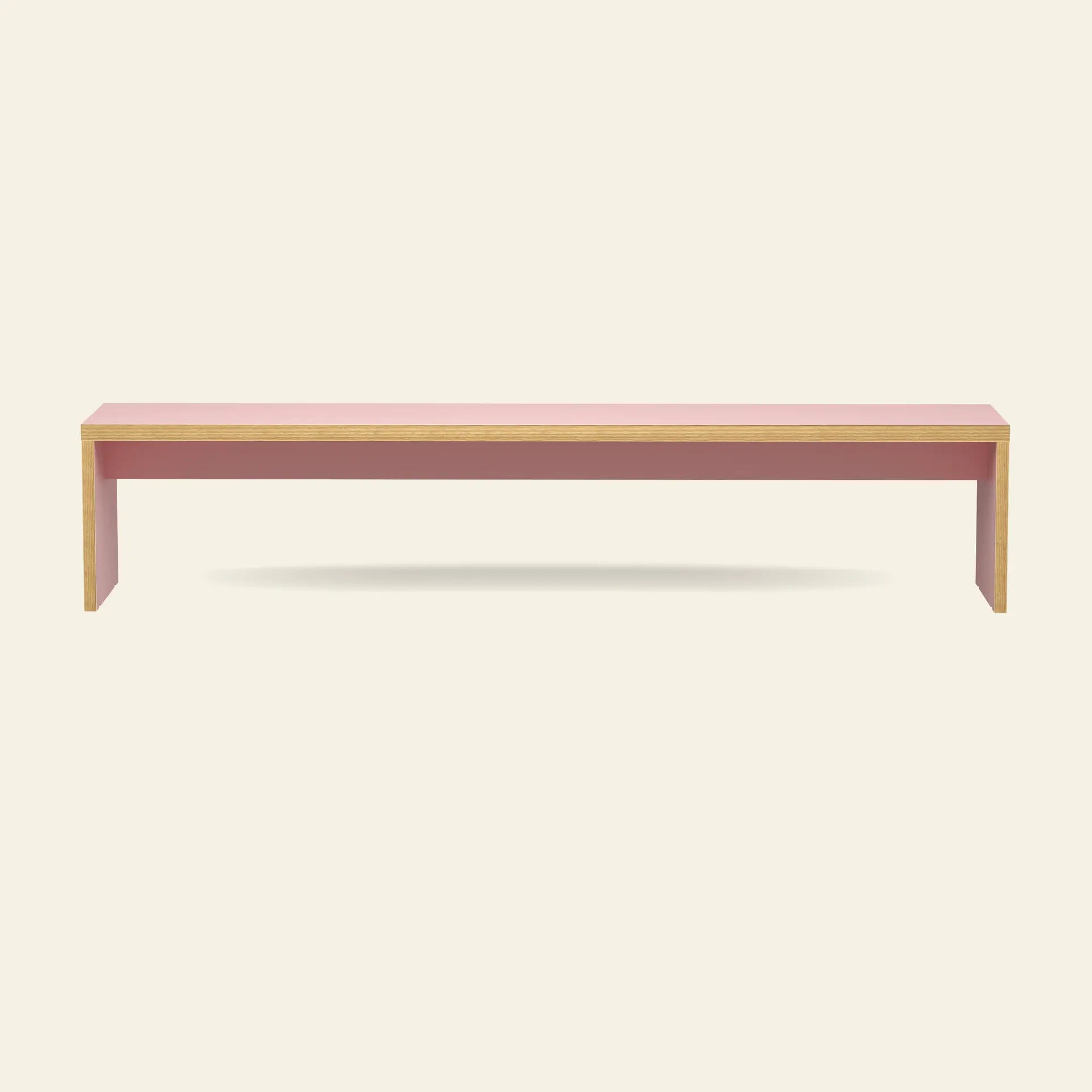 The HKliving Bench, 220cm, by HKliving features a minimalist pink top and light wooden sides—ideal as space-saving dining table seating—shown against a plain off-white background.