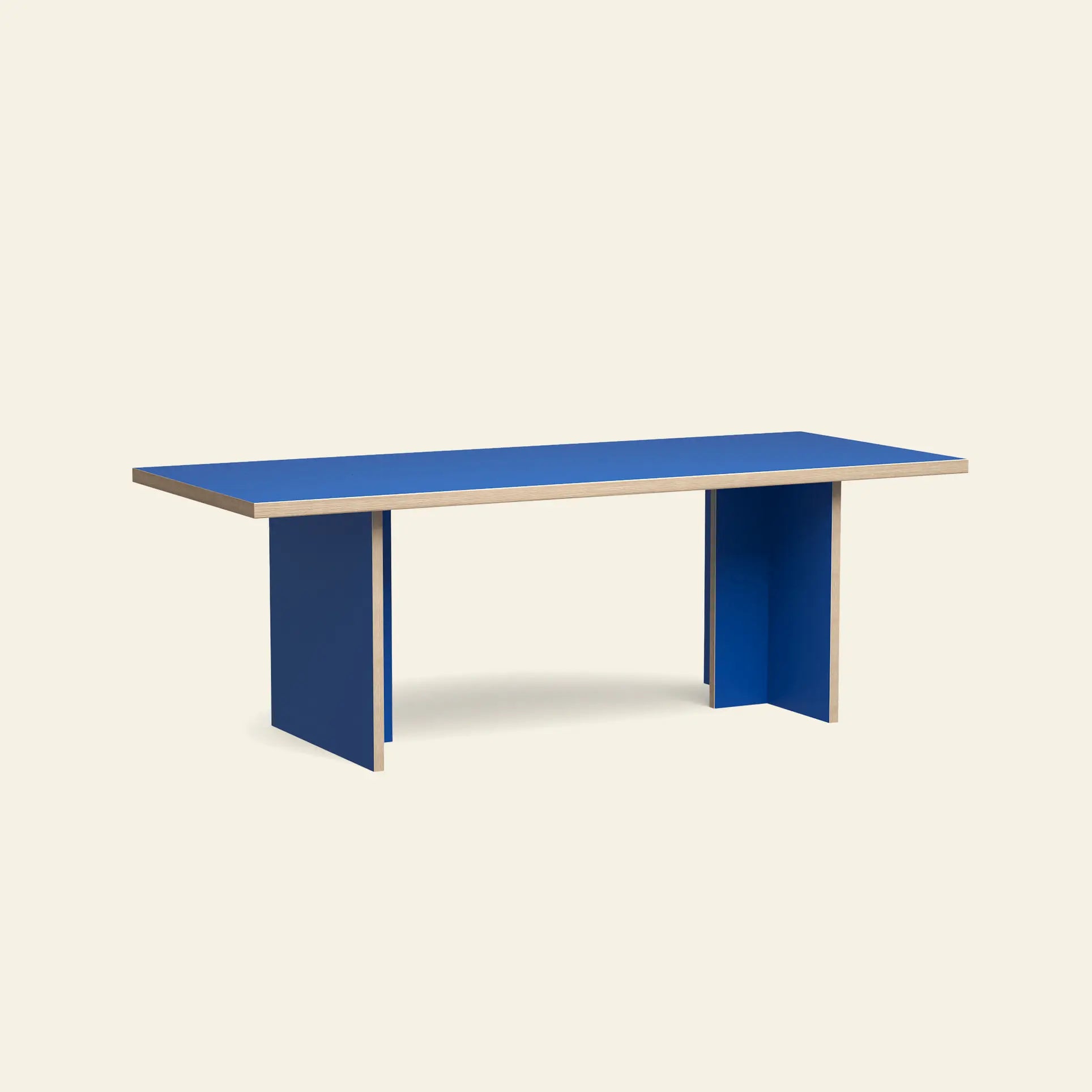 The HKliving Dining Table, Rectangular, 220cm, features a flat blue top and thick blue panel legs against an off-white background—a timeless piece by HKliving that fits standard spaces with modern style.