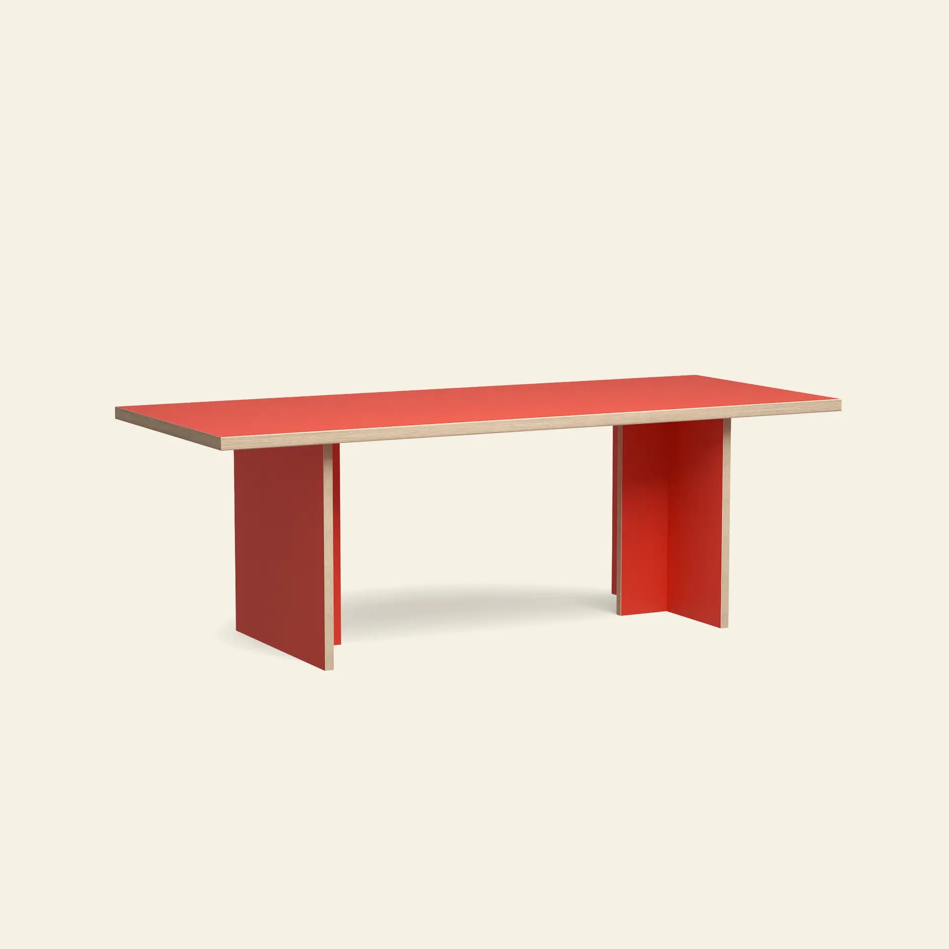The HKliving Dining Table, Rectangular, 220cm by HKliving features a red tabletop, panel legs, light wood trim, and a minimalistic design with clean lines, set against a plain beige background. Available in standard sizes.