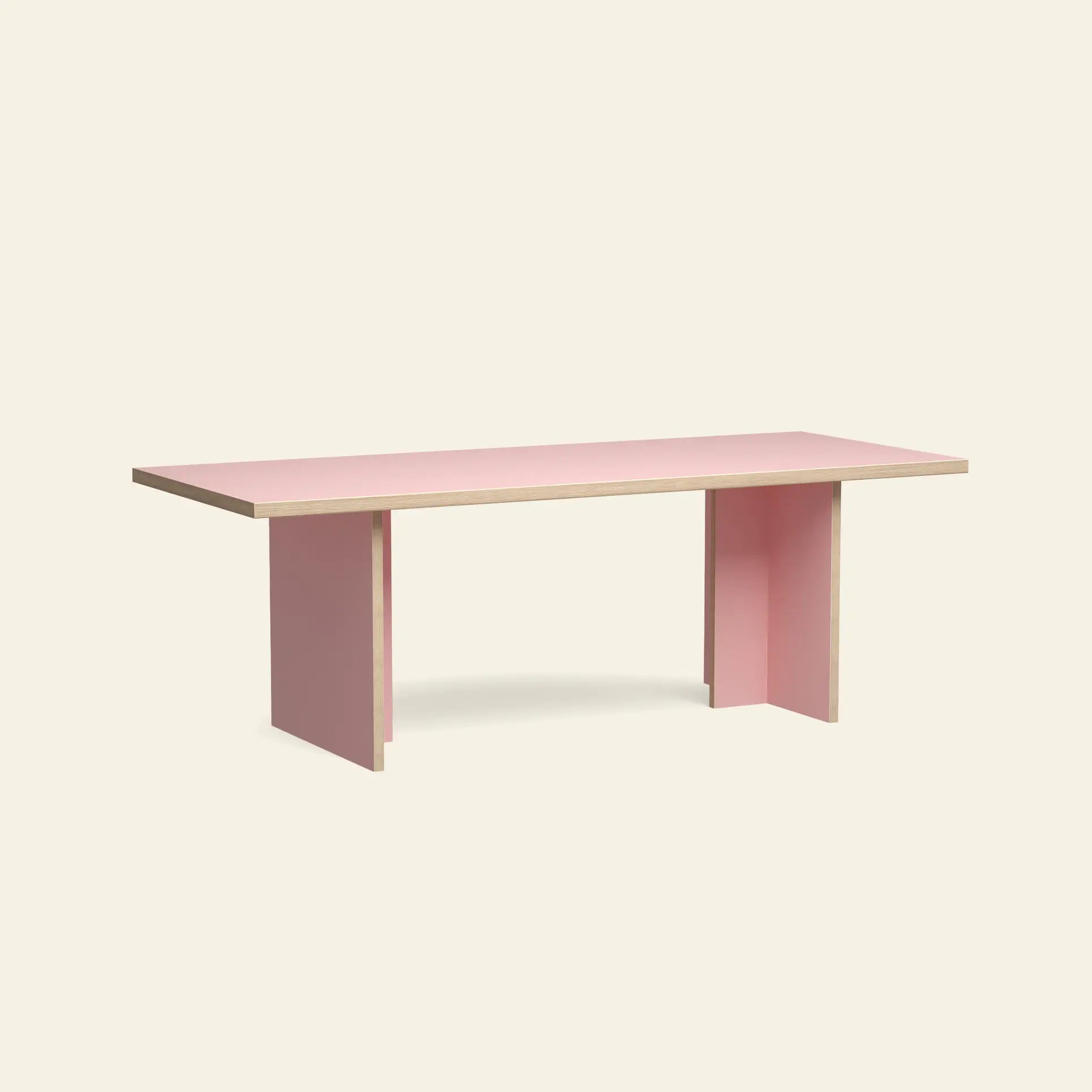 The HKliving Dining Table, Rectangular, 220cm by HKliving features a minimalist design with a pink surface, light wood edge, and two wide pink legs at each end—perfect for standard dining spaces and styled against a plain beige background.