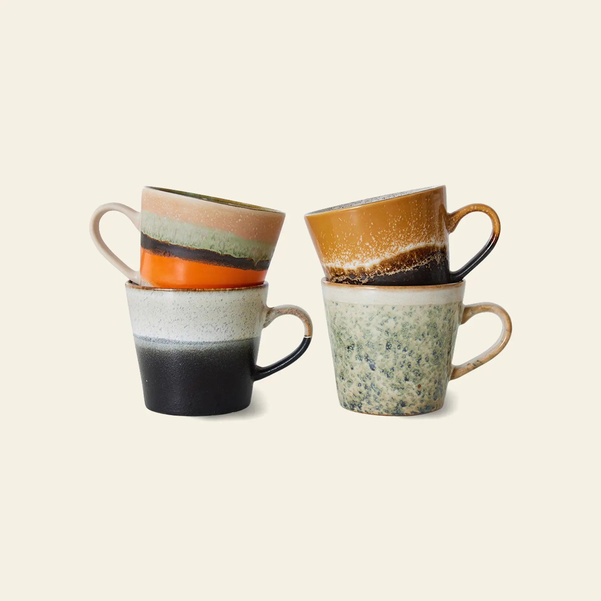 The HKliving 70s Ceramics: Cappuccino Mugs, Set of 4 features uniquely colored and patterned ceramic mugs with a rustic, speckled finish—perfect for coffee bar decor. Each piece reflects the signature earthy style of HKliving.