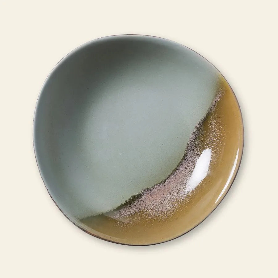 The HKliving 70s Ceramics: Curry Bowls, Set of 2 features round ceramic bowls with uneven rims and a gradient green-brown glaze, evoking vintage 70s style, set off against a light beige background.