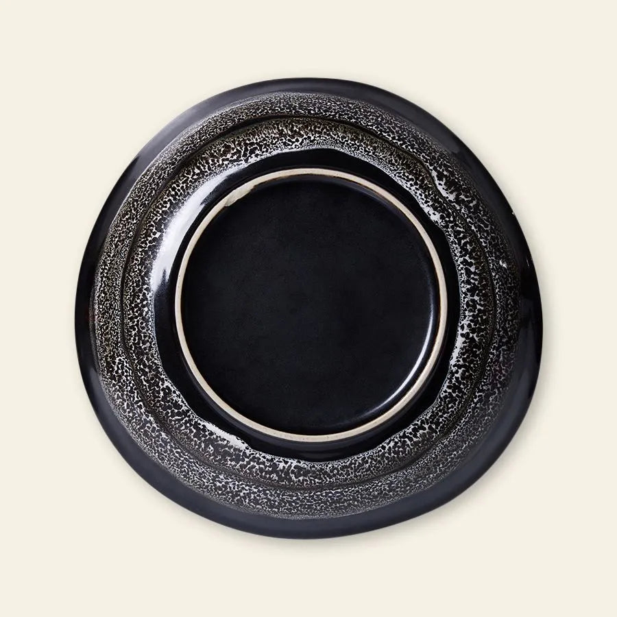 The HKliving 70s Ceramics: Curry Bowls (Set of 2) feature glossy black centers and speckled gray rims, inspired by vintage ceramics—perfect for adding a retro touch to your table.