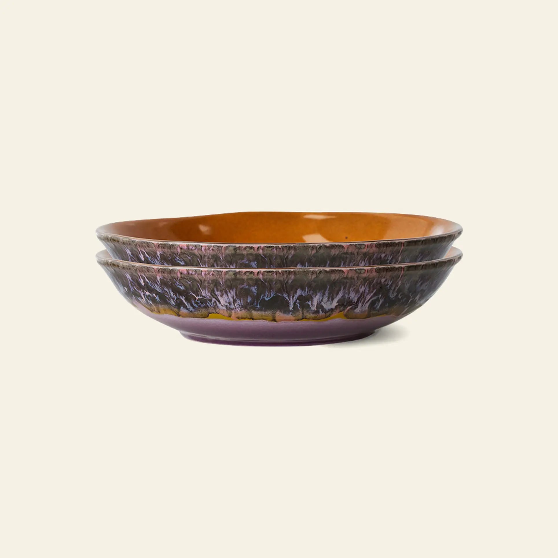 The HKliving 70s Ceramics: Curry Bowls, Set of 2 features a glossy brown interior and textured dark purple-black exterior, capturing retro charm against a plain background.
