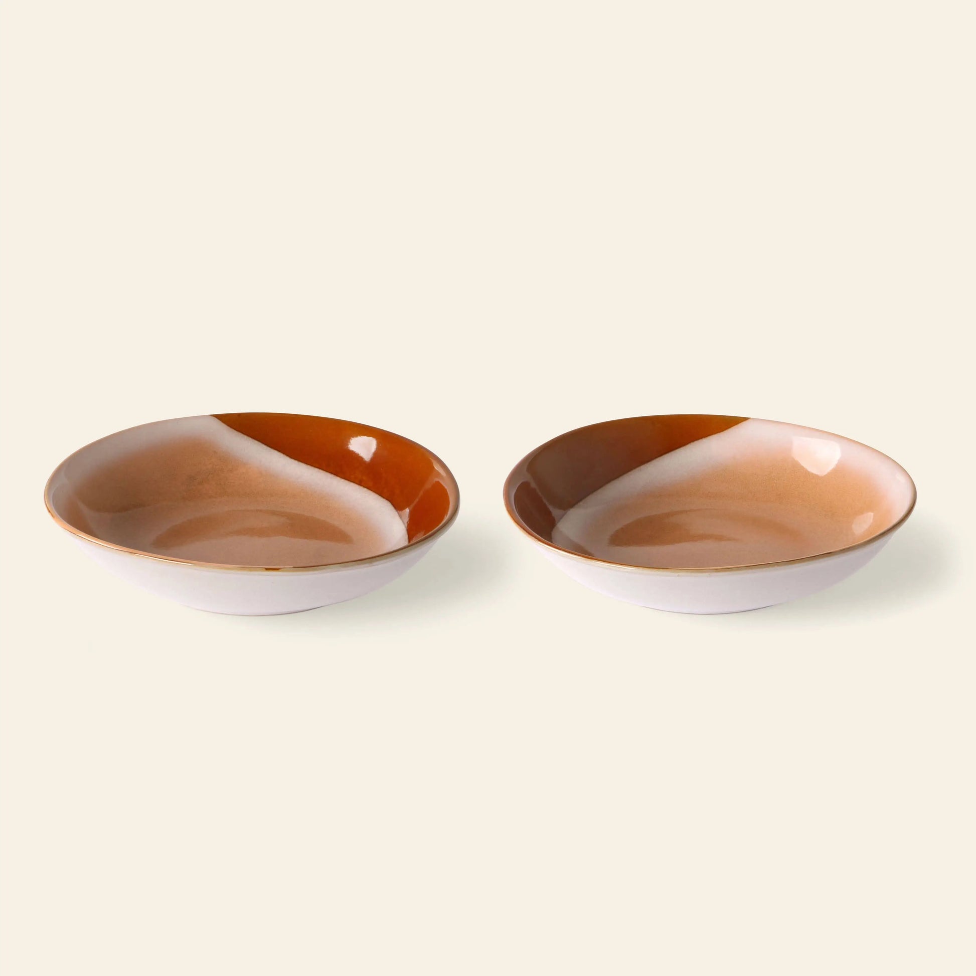 The HKliving 70s Ceramics: Curry Bowls, Set of 2 features round beige and brown bowls side by side on a light background—ideal for bringing retro flair and vintage style to your table.
