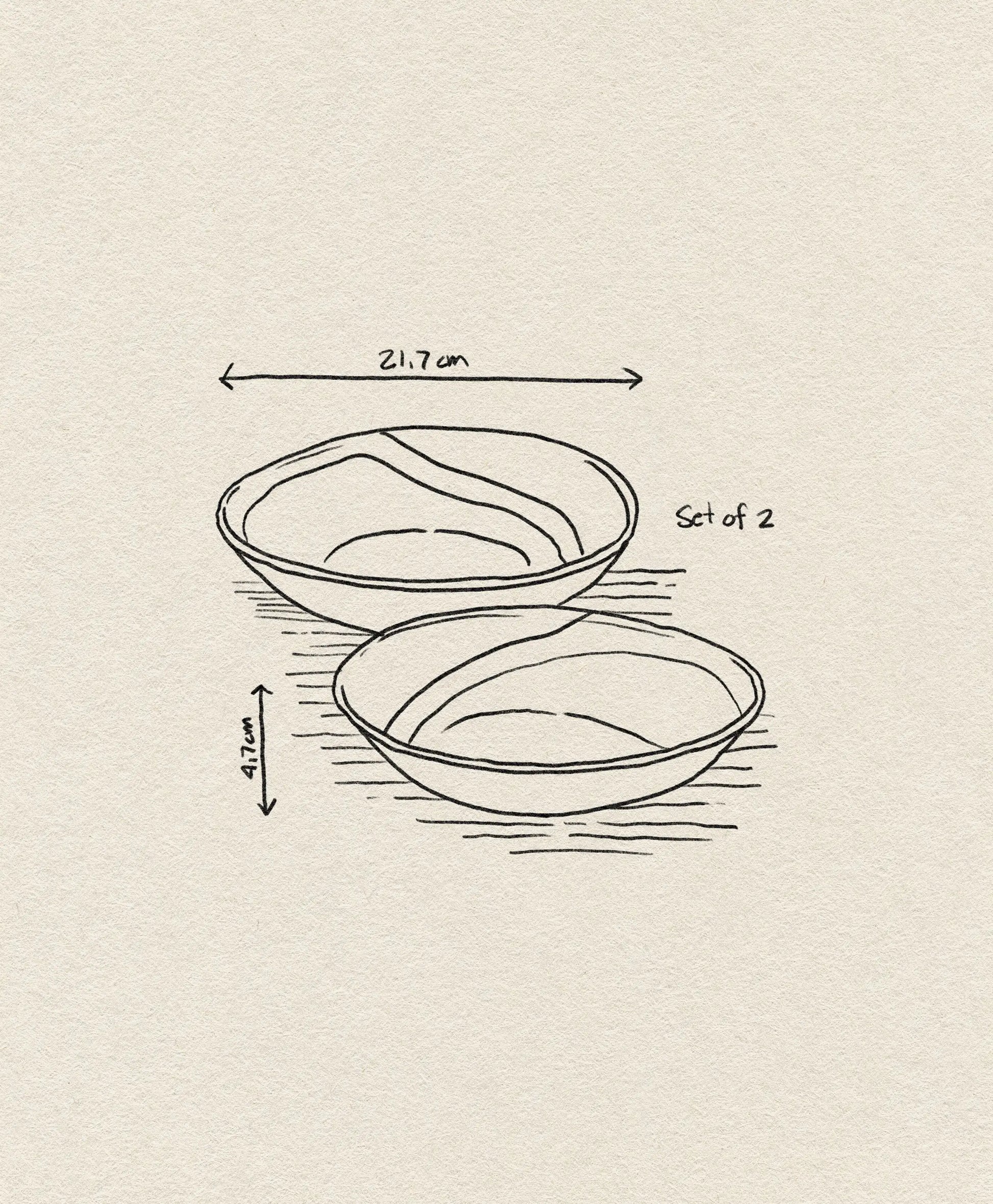 A simple line drawing of HKliving 70s Ceramics: Curry Bowls, Set of 2 by HKliving, each measuring 21.7 cm in diameter and 4.7 cm high, shown on a textured beige background.