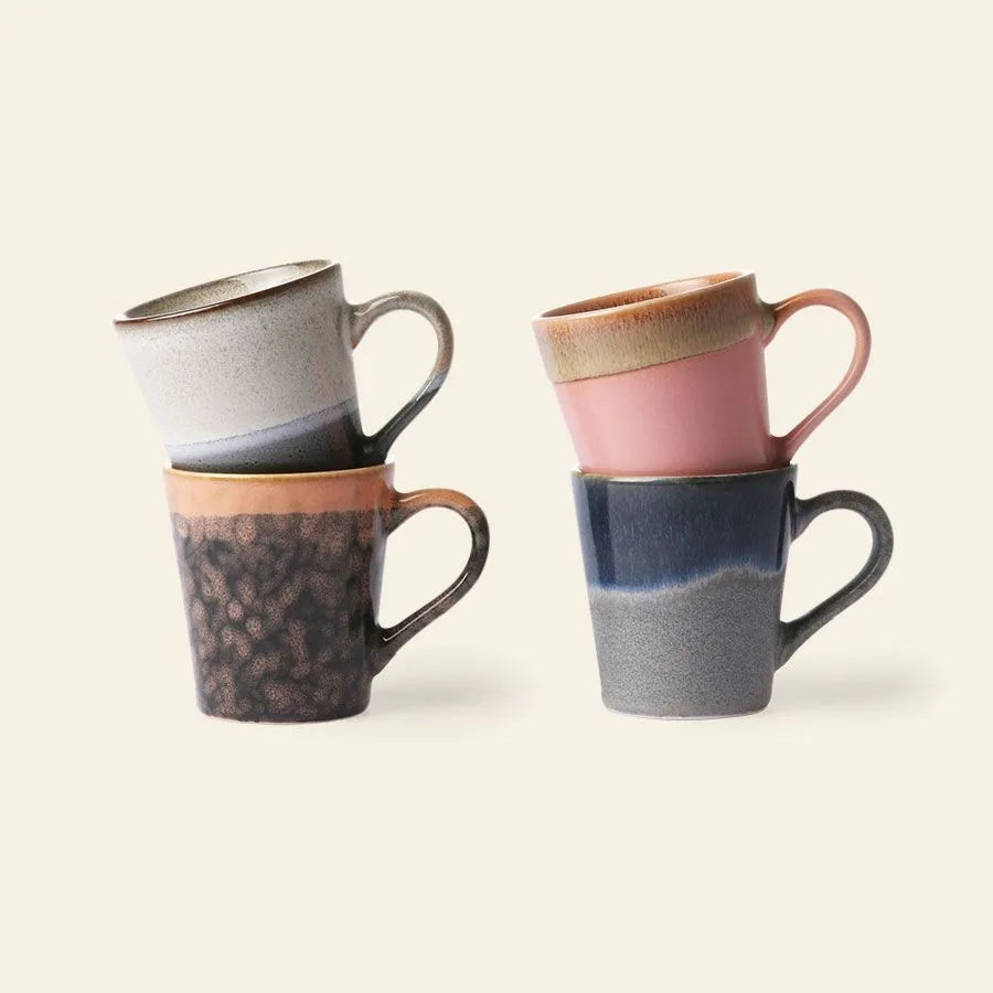 Four HKliving 70s Ceramics espresso mugs (80ml each) are stacked in two columns; the ceramic set features grey, blue, pink, and brown hues with varied textured finishes and patterns.