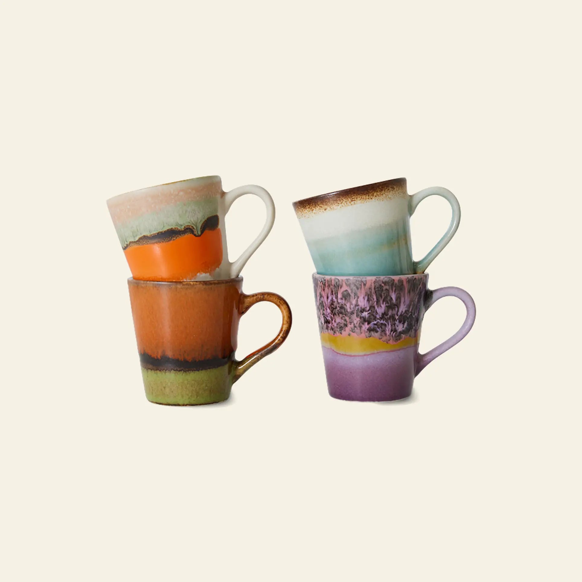 The HKliving 70s Ceramics: Espresso Mugs, Set of 4 includes four 80ml ceramic mugs with unique colorful layered designs in orange, green, purple, and blue tones—perfect for adding retro charm to your kitchen.