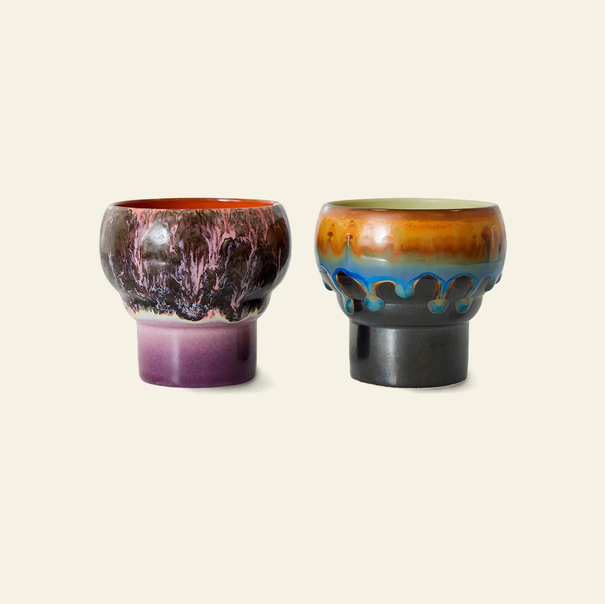 The HKLIVING 70s Ceramics: Lungo Mugs, Set of 2 features vibrant designs—one marbled in purple and red, the other in earth tones with blue and brown drip—ideal for coffee lovers seeking style and quality from HKLIVING.