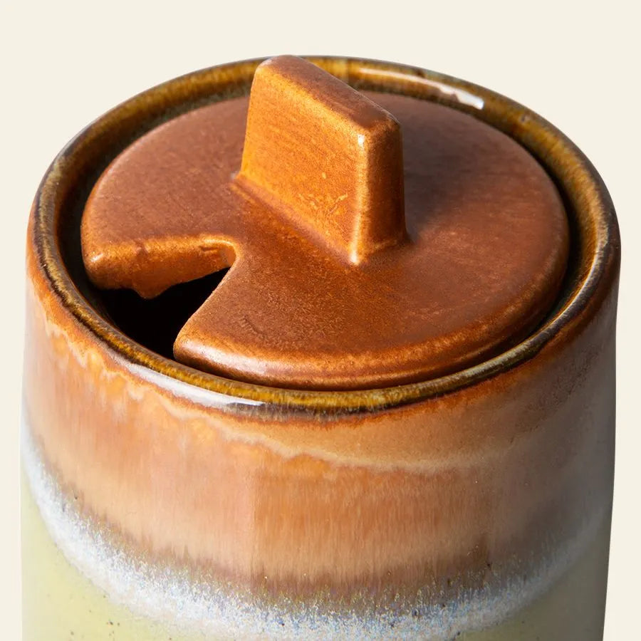 A close-up of the HKliving 70s Ceramics Sugar Pot from the HKliving 70s Ceramics Milk Jug & Sugar Pot set, featuring a brown glossy lidded pot with a notch for a spoon and a striking brown-to-cream gradient glaze.