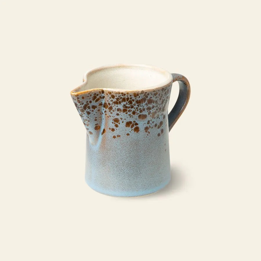 The HKliving 70s Ceramics: Milk Jug & Sugar Pot features a handled ceramic milk jug with a blue base and brown speckled top, echoing classic 70s style, by HKliving—shown on a plain light background.
