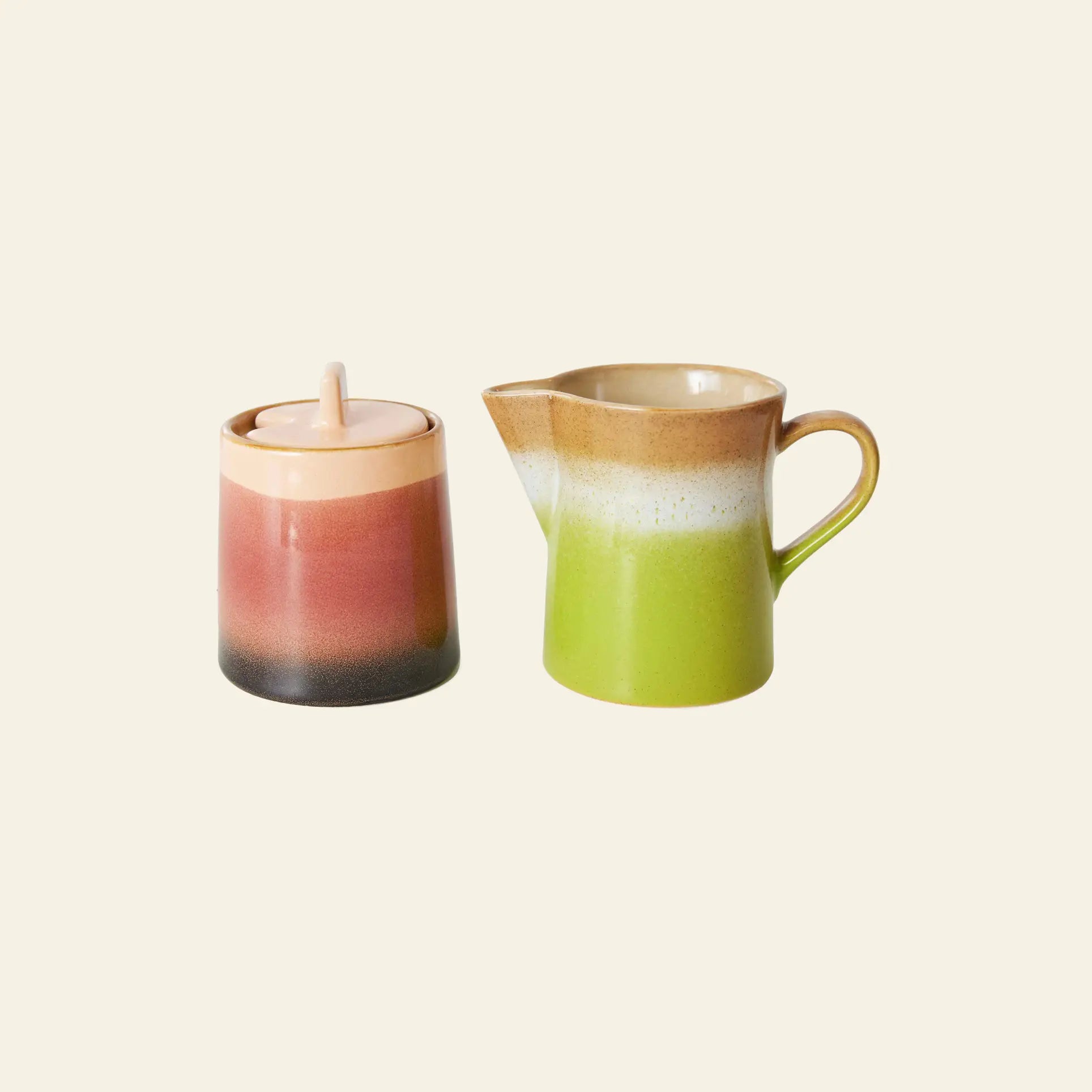 The HKliving 70s Ceramics: Milk Jug & Sugar Pot set by HKliving features a ceramic milk jug and sugar pot with lids, showcasing a pink, brown, white, and green gradient inspired by 70s ceramics against a plain background.
