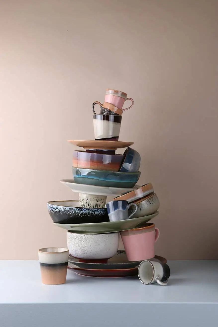 A stack of HKliving 70s Ceramics Noodle Bowls (Set of 4) sits on a white surface against a beige background—perfect for serving your favorite dishes in style, even if the arrangement looks artfully balanced.