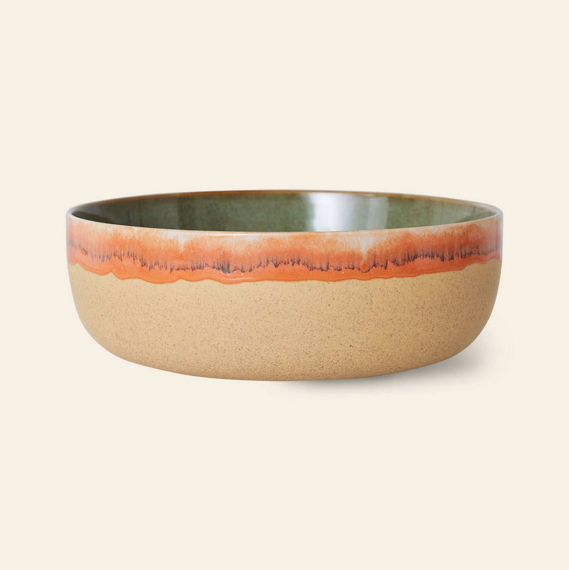 The HKliving 70s Ceramics: Salad Bowl by HKliving features retro charm with a matte tan exterior, glossy green interior, and an orange dripped glaze rim, set against a light beige background.
