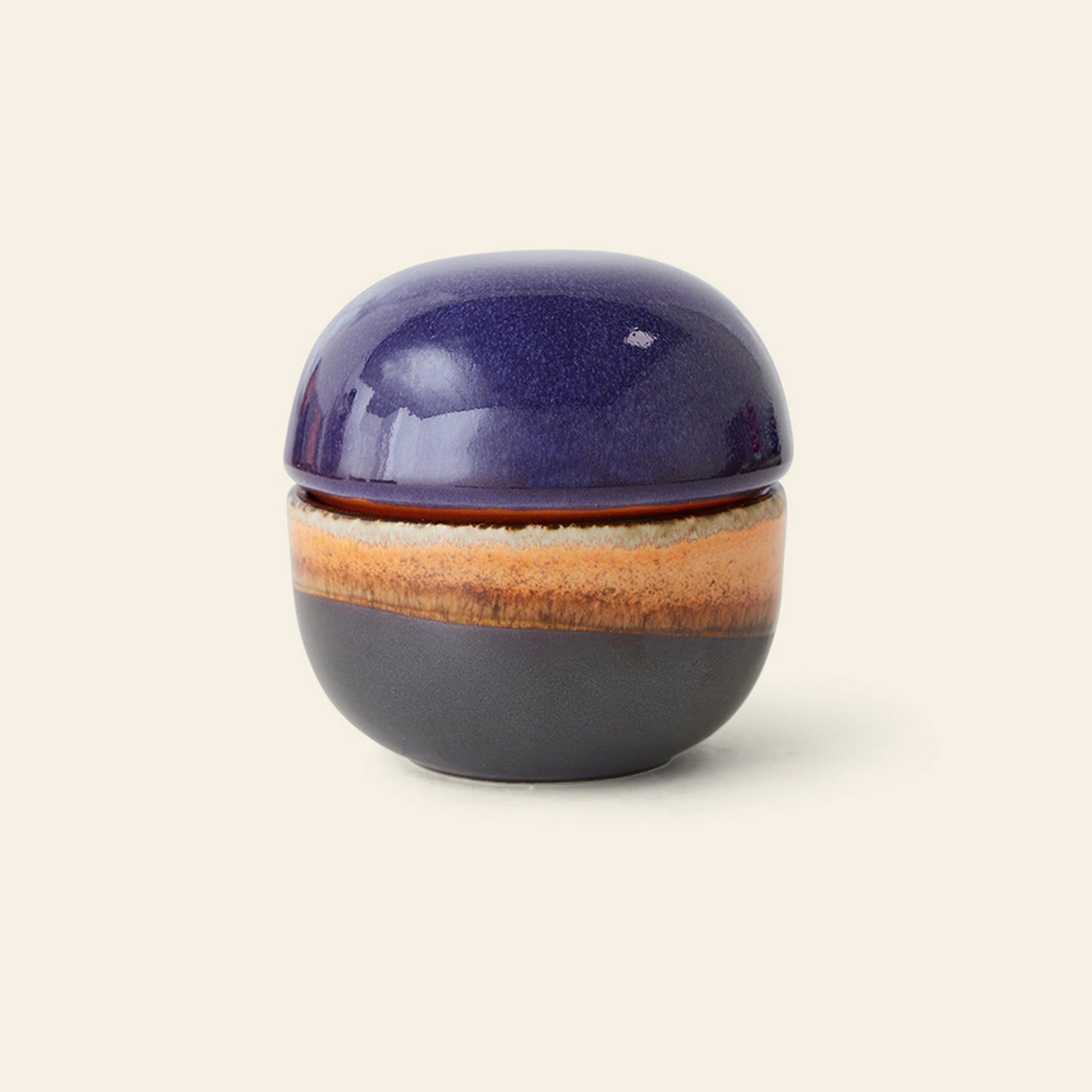 The HKliving 70s Ceramics: Sugar Pot by HKliving features a glossy deep purple lid and layered purple, orange, and tan hues—a stylish, versatile ceramic container ideal for storing condiments.
