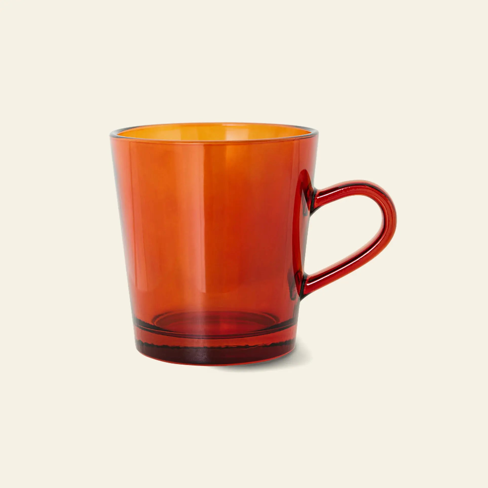The HKliving 70s Glassware: Coffee Cups (set of 4) are translucent, amber mugs with handles from the vibrant HKliving collection, shown against a plain light beige background.
