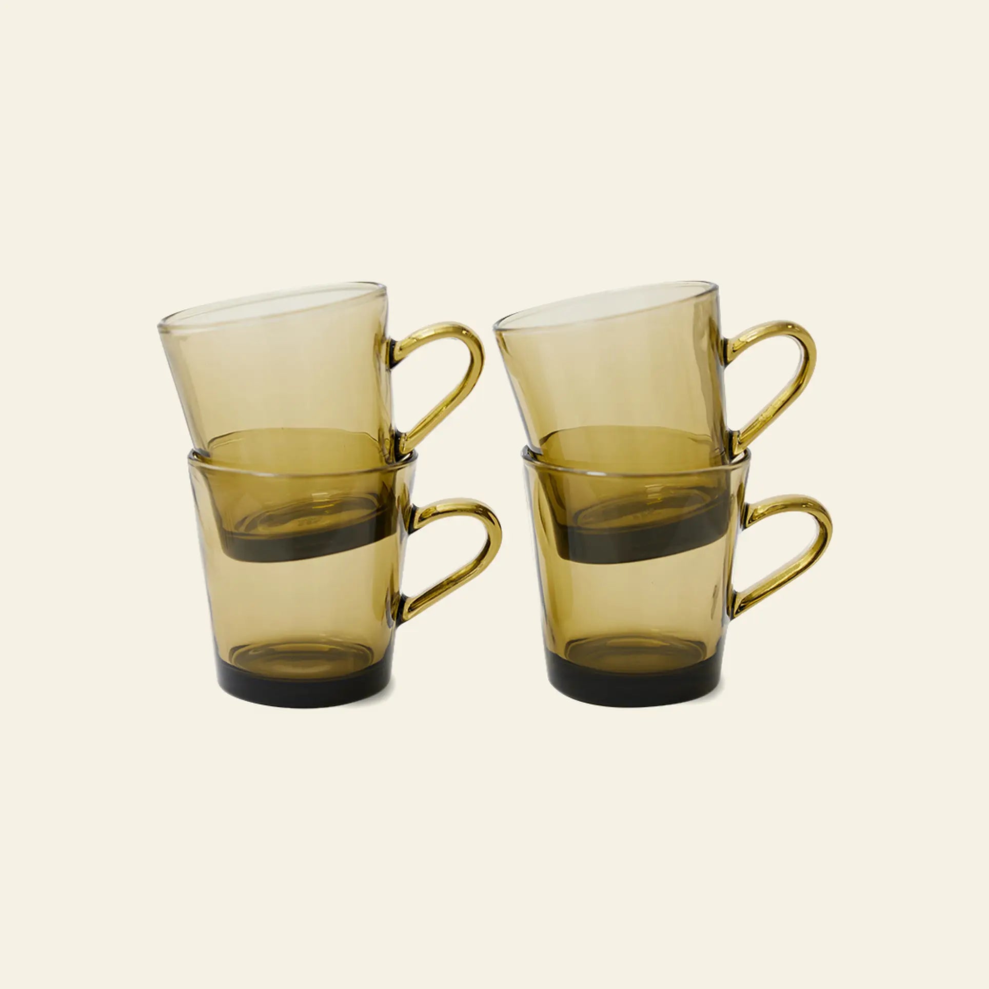 The HKliving 70s Glassware Coffee Cups Set of 4 features stacked amber mugs with handles, inspired by retro design, and perfect as heat-resistant coffee cups.