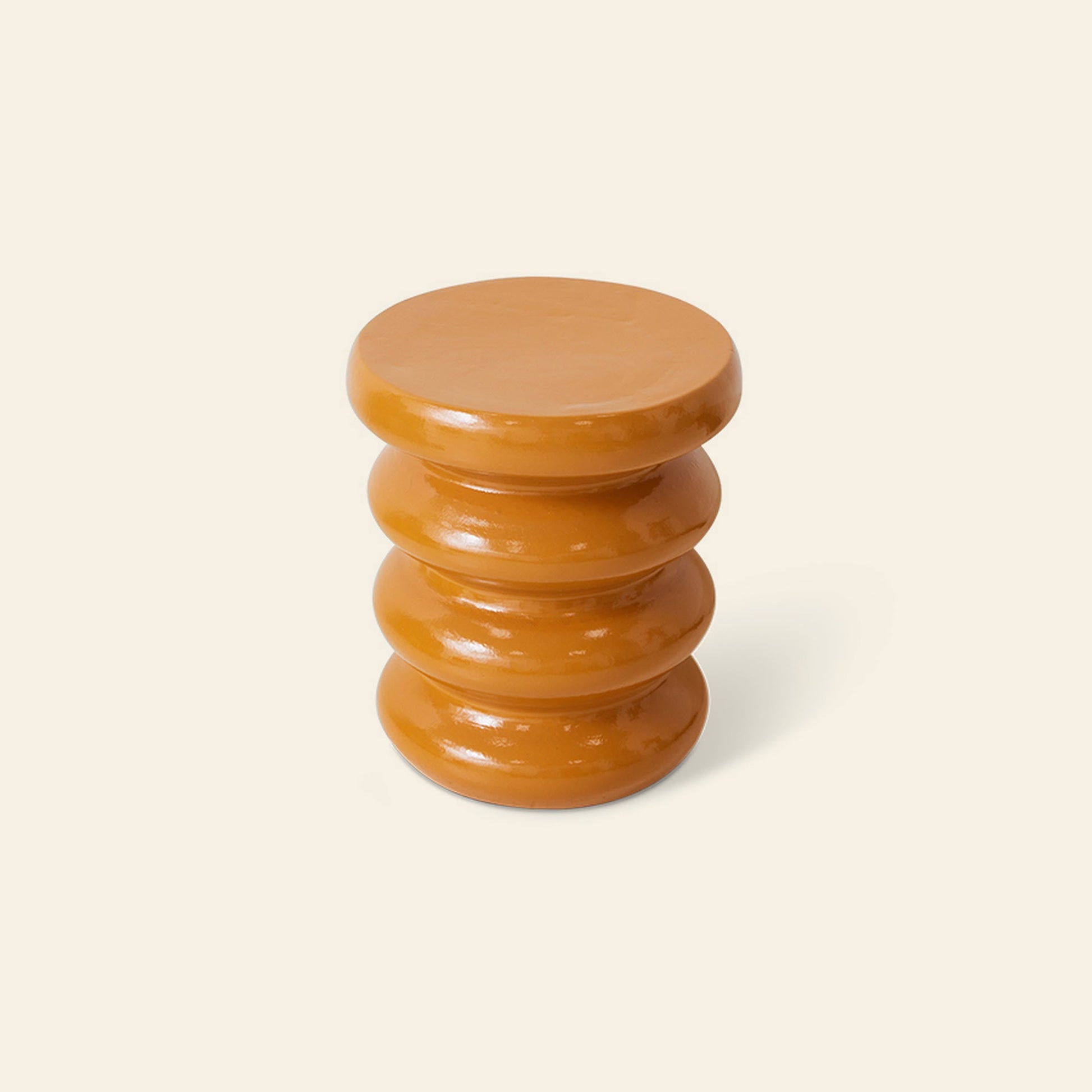 The HKliving Allure Side Table by HKliving features a glossy, cylindrical orange design with four rounded, stacked sections, displayed on a light beige background for a modern, sophisticated look.