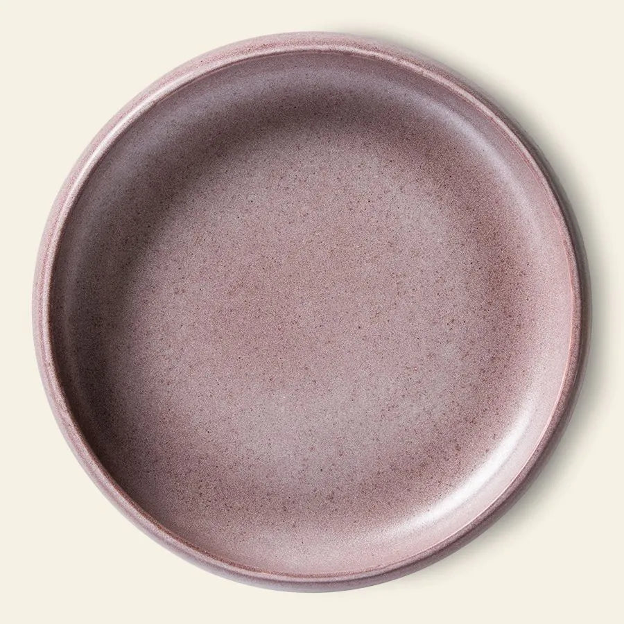 The HKliving Bold & Basic Ceramics: Deep Plate Set of 2 features round mauve-pink ceramic plates with raised rims, ideal for elegant presentations, shown from above against a light cream background.