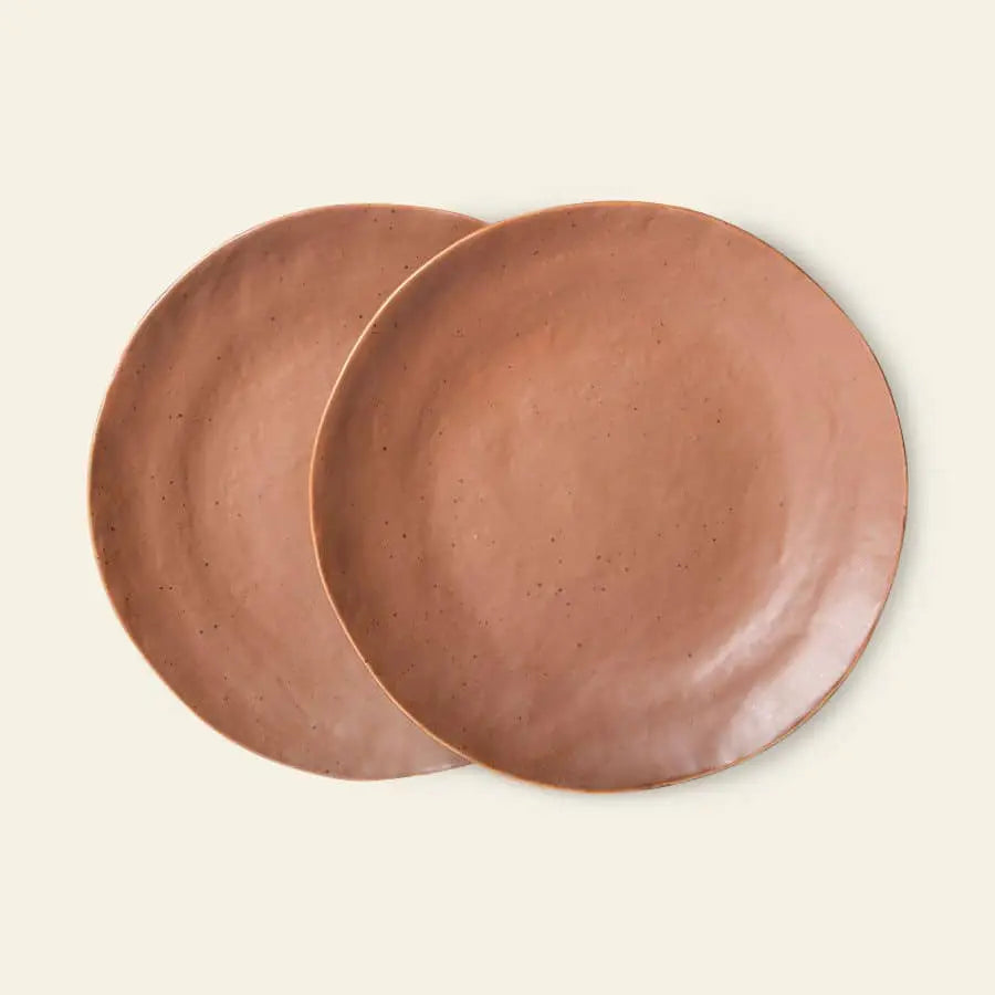 Two terracotta-hued HKliving Bold & Basic Ceramics side plates (set of 2) display a handcrafted look with slightly uneven surfaces, shown overlapping on a light beige background.