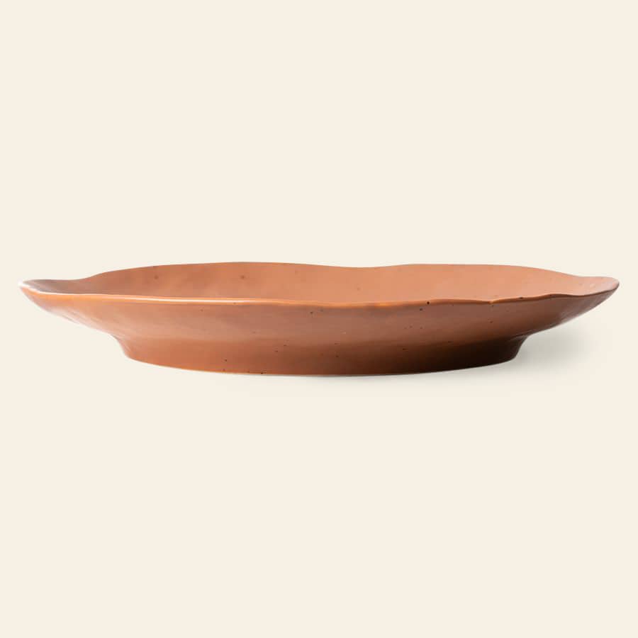 The HKliving Bold & Basic Ceramics Side Plate Set of 2 features shallow, oval terracotta plates with wavy rims, displayed against a plain light background.