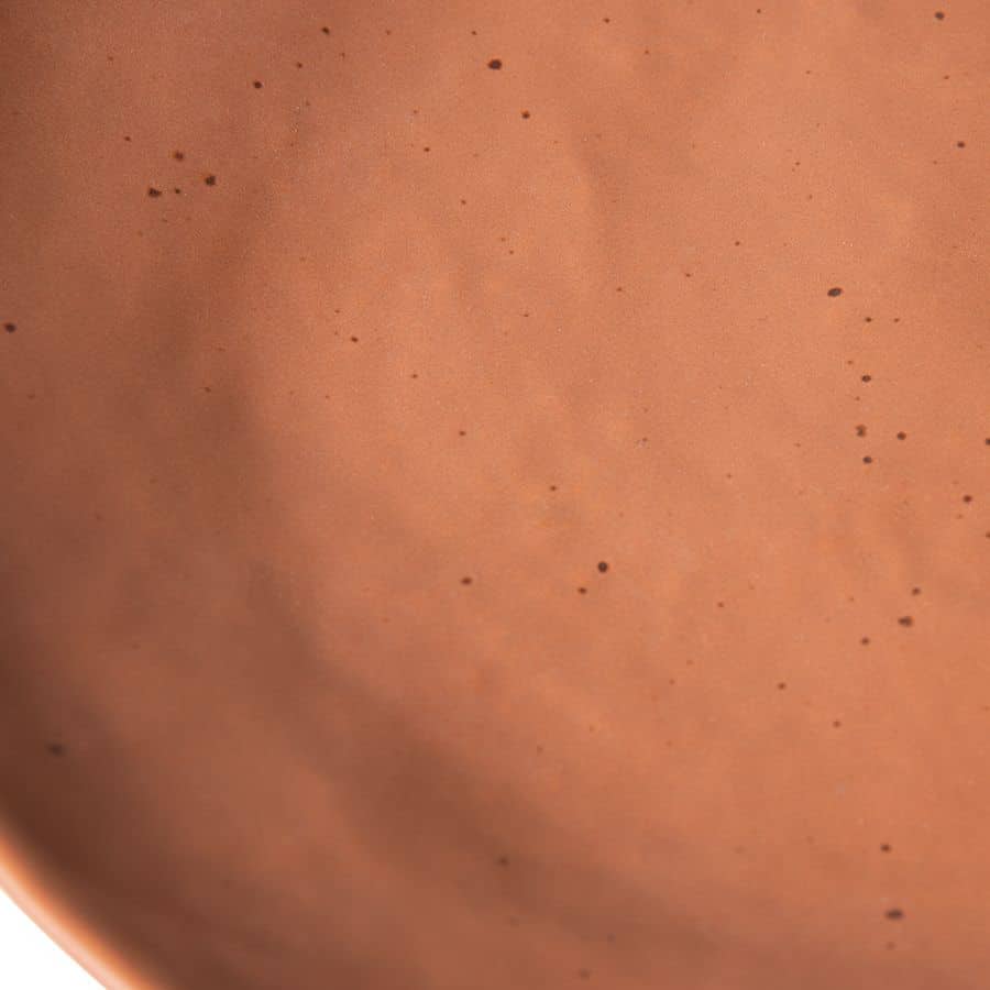 Close-up of the terracotta-colored HKliving Bold & Basic Ceramics Side Plate (Set of 2), showing small black speckles and a smooth, matte ceramic texture.