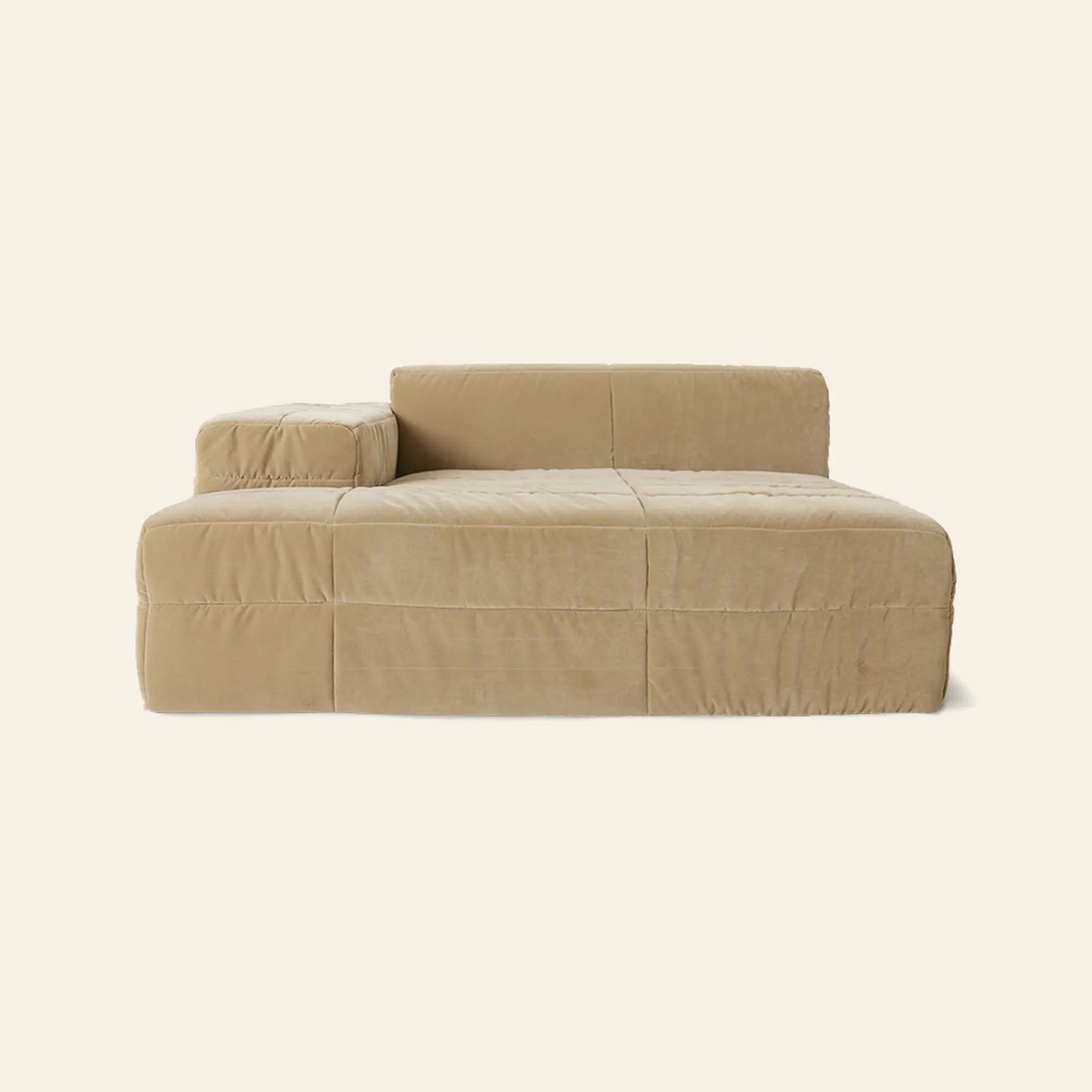 The HKliving Brut Sofa, Left by HKliving is a modern beige modular sofa with spacious seating, plush cushions, and clean lines for total comfort—showcased in a low-profile design against an off-white background.
