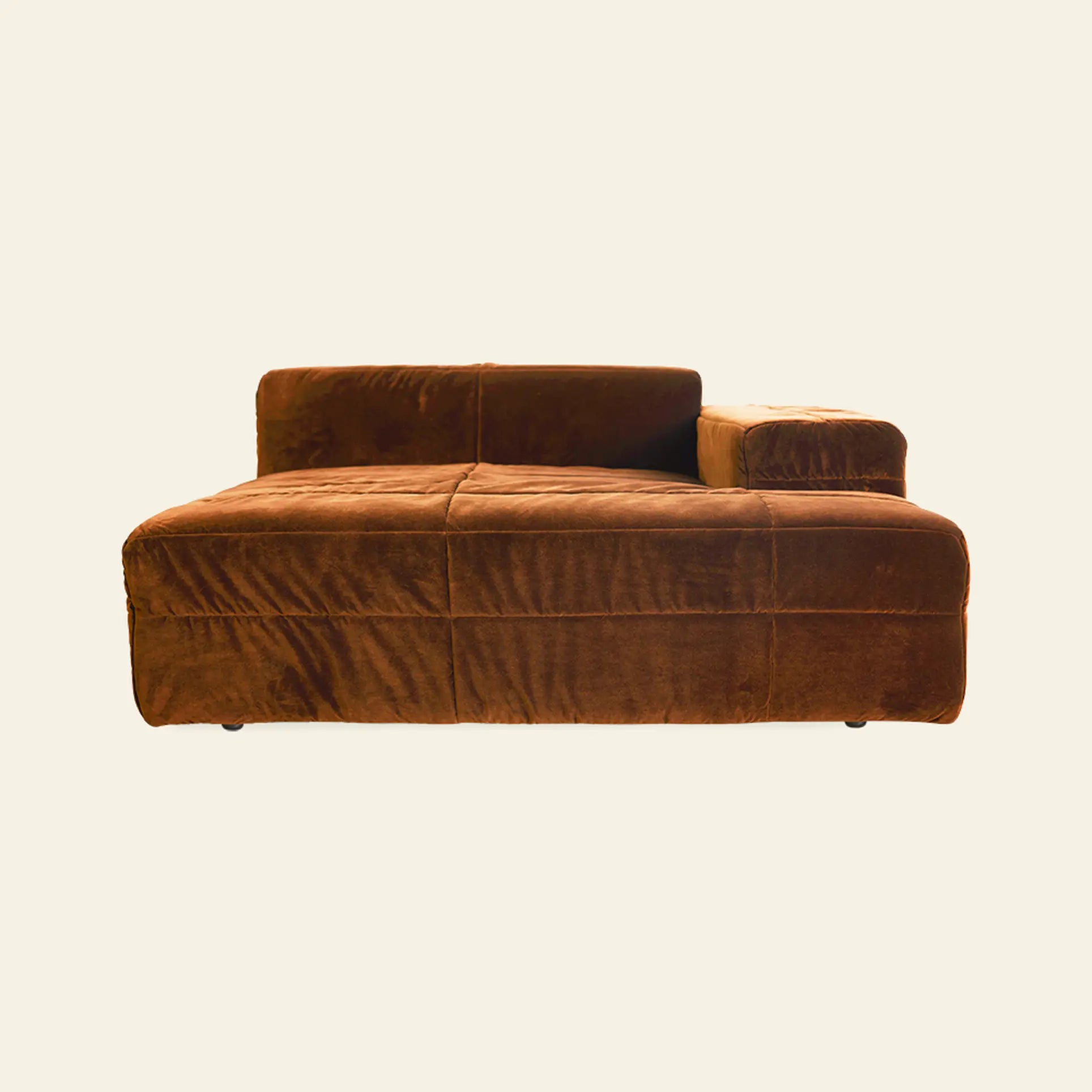 The HKliving Brut Sofa, Right Divan by HKliving is a brown velvet chaise lounge with a low backrest and a single right armrest, offering spacious seating against a plain light background.