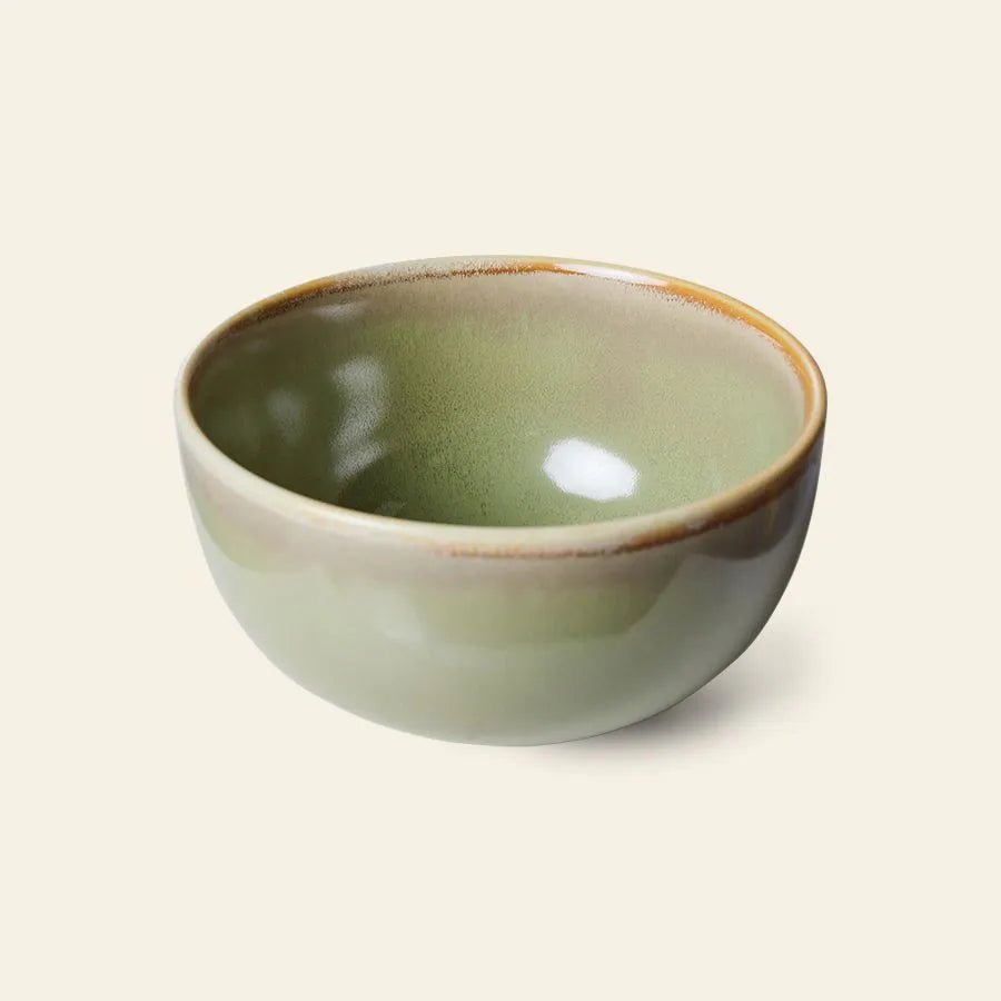 The HKliving Chef Ceramics: Bowl by HKliving features a smooth, light green reactive glaze with a glossy finish and subtle brown rim—an elegant ceramic piece to elevate your tableware, shown on a plain beige background.