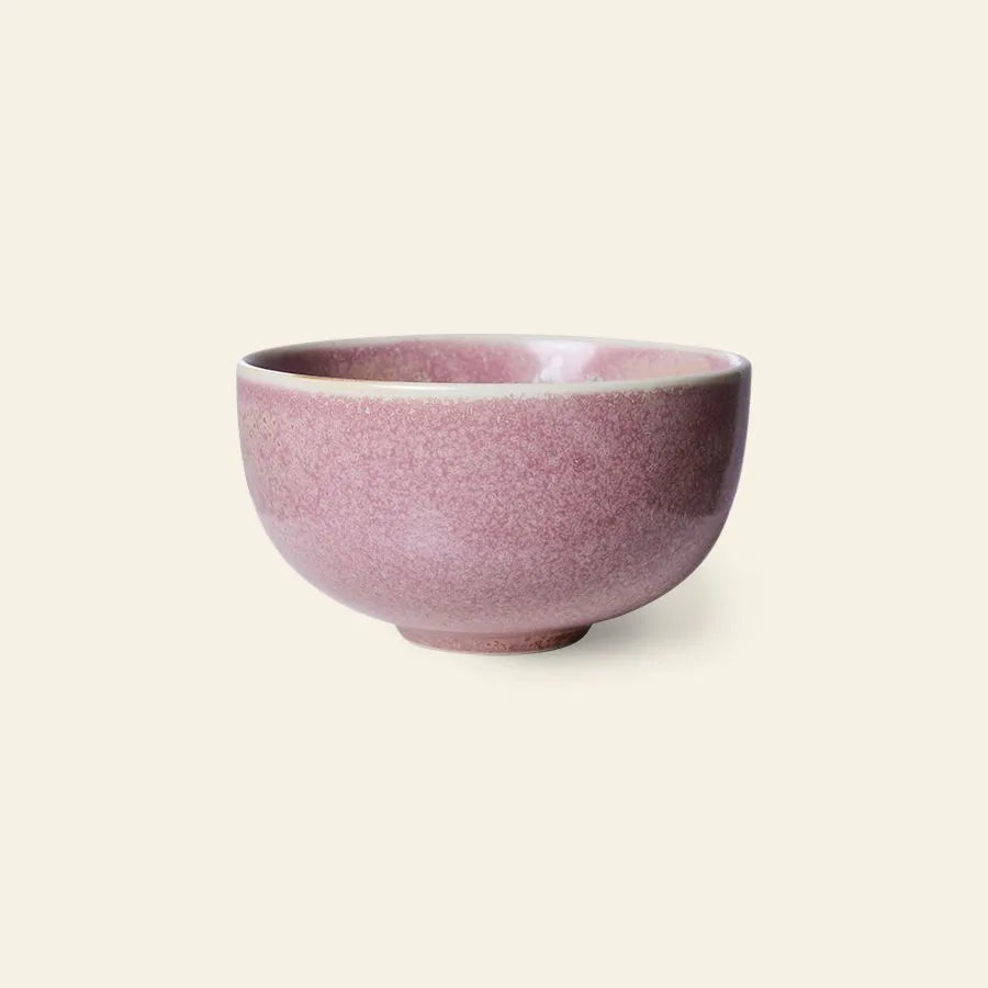 The HKliving Chef Ceramics: Bowl features a small, rounded ceramic shape with a soft pink reactive glaze—an essential piece by HKliving to elevate your tableware collection, shown against a plain light background.