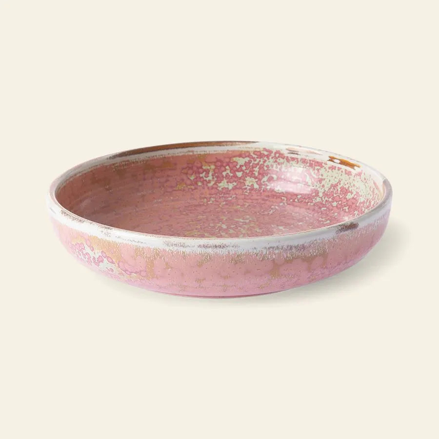 The HKliving Chef Ceramics: Deep Plate M by HKliving, featuring a pink and cream reactive glaze, exudes artisanal charm against a simple light backdrop.