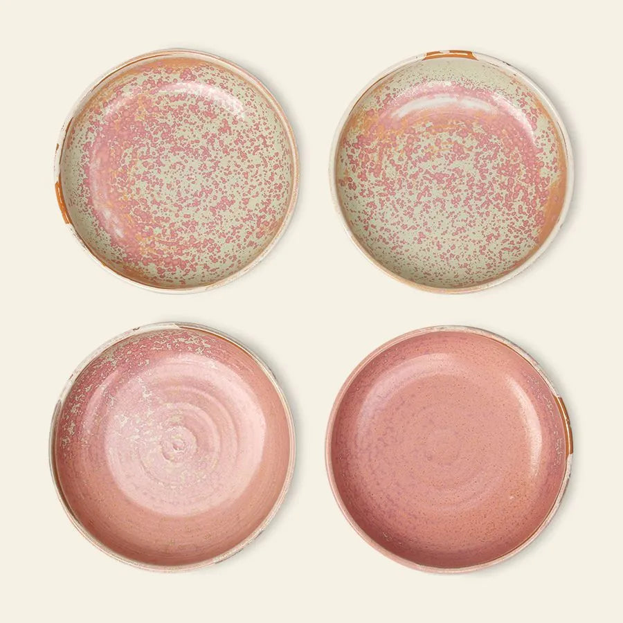 Four HKliving Chef Ceramics: Deep Plate M pieces are arranged in a square, each featuring artisanal charm and unique speckled pink and cream reactive glaze, highlighting the handmade appeal against an off-white background.
