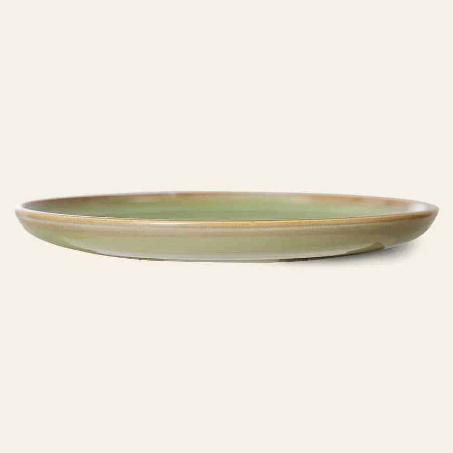 The HKliving Chef Ceramics Dinner Plate by HKliving is a green ceramic plate with a slightly raised rim, shown from the side on a plain light background—an elegant upgrade to your tableware.