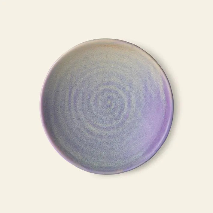 The HKliving Chef Ceramics: Flat Bowl features a smooth, speckled ceramic surface in pastel purple and light blue with subtle circular ridges. Hand finished by HKliving, this essential piece stands out against an off-white backdrop.