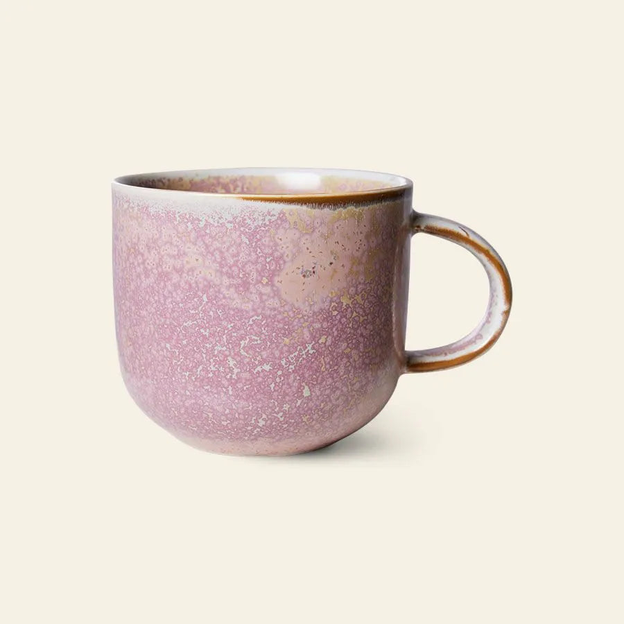 The HKliving Chef Ceramics: Mug by HKliving features a pink and lavender speckled glaze and large handle, adding artisanal charm to your tableware and standing out beautifully against a plain light background.