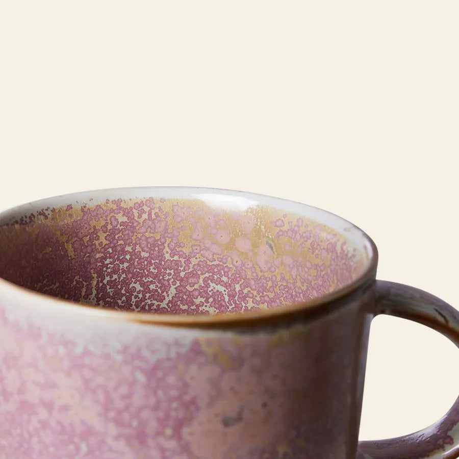 A close-up of the HKliving Chef Ceramics: Mug by HKliving, featuring a speckled pink and beige glaze with handle and rim detail, showcases its artisanal charm against a plain light background.