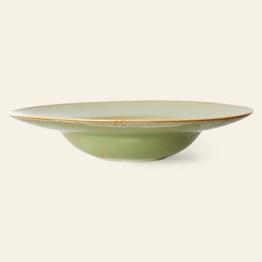 The HKliving Chef Ceramics: Pasta Plate by HKliving is a shallow, round, light green bowl with a wide rim and subtle brown edge—ideal for pasta or other dishes—shown against a plain beige background.