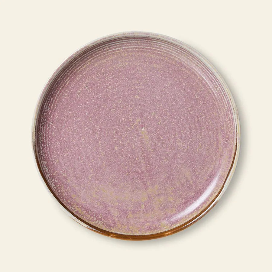 The HKliving Chef Ceramics: Side Plate is a round ceramic plate with a glossy lavender-pink reactive glaze, earthy brown edges, and is showcased on a light beige background.
