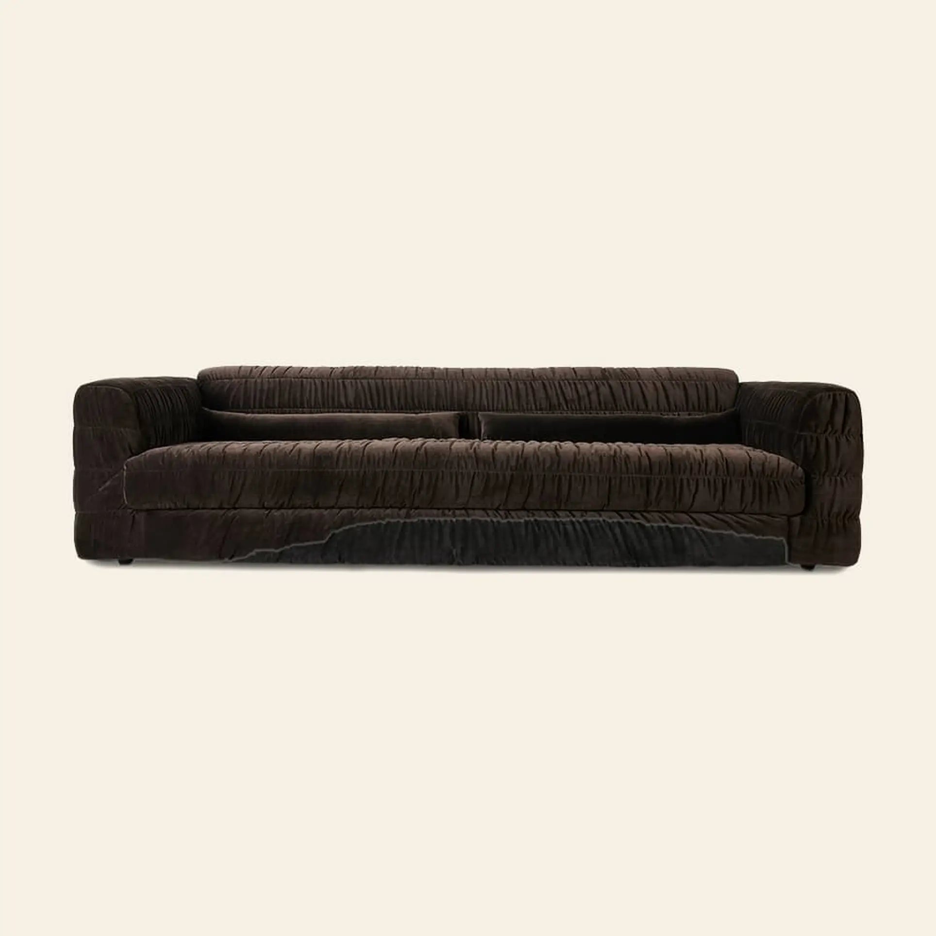 The HKliving Club Couch by HKliving features dark brown plush velvet, a low back, and pleated upholstery for superb comfort, displayed against a plain light beige background.