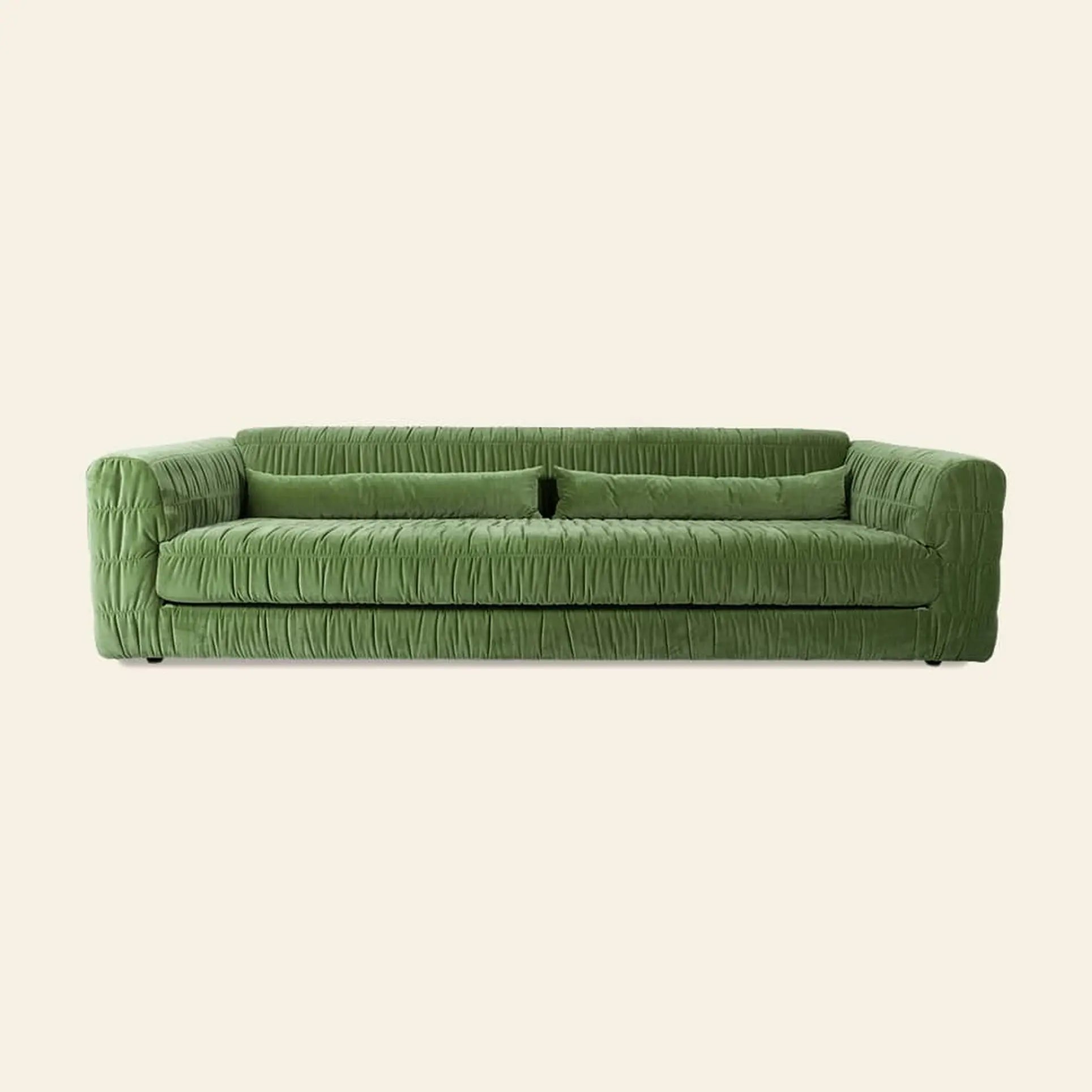 The HKliving Club Couch by HKliving is a modern green sofa with pleated upholstery, a rectangular design, and low wide armrests for comfort and minimalist appeal, shown against a plain light background.