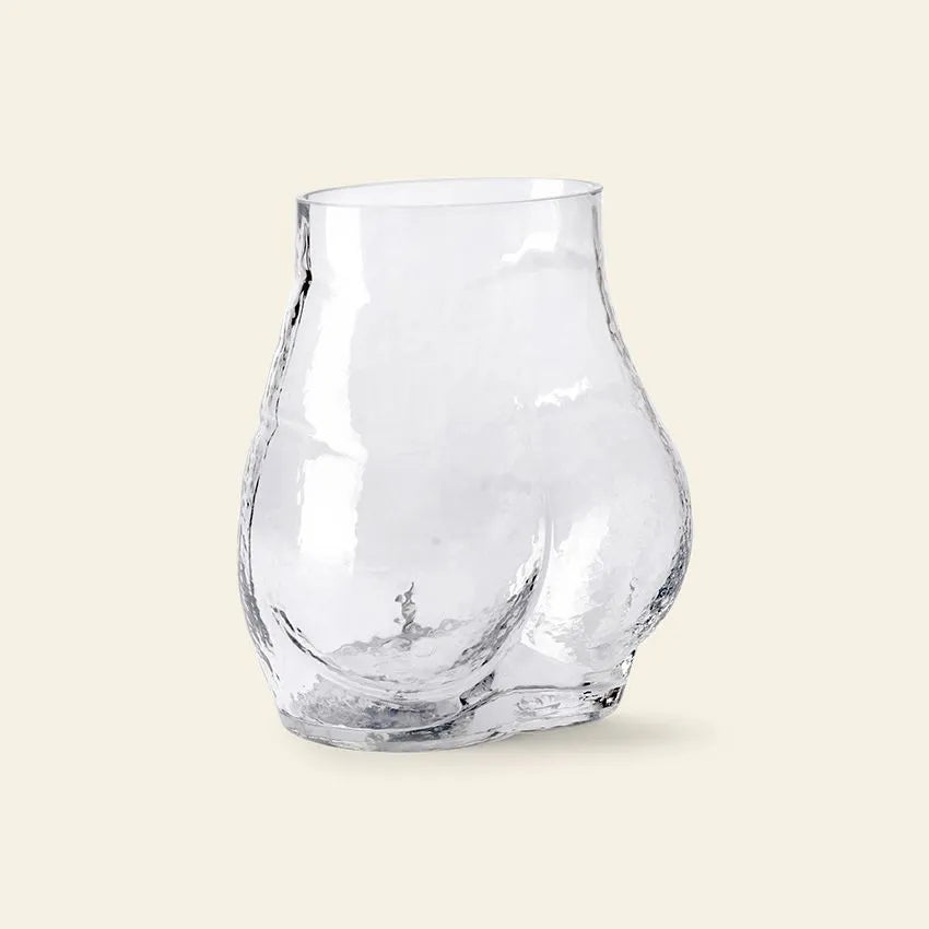 The HKliving Glass Bum Vase by HKliving features a transparent glass design shaped as a curvy human torso from the waist down, with detailed hips and buttocks, presented against a plain light background.